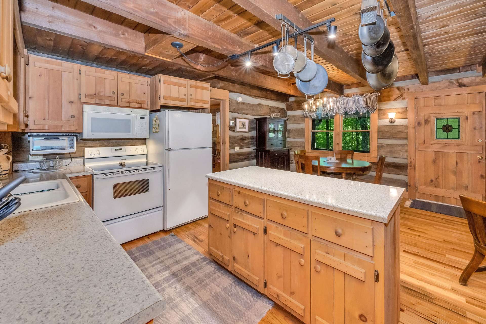 The central island adds prep surface, hidden storage, and a natural hub for friends and family to gather.