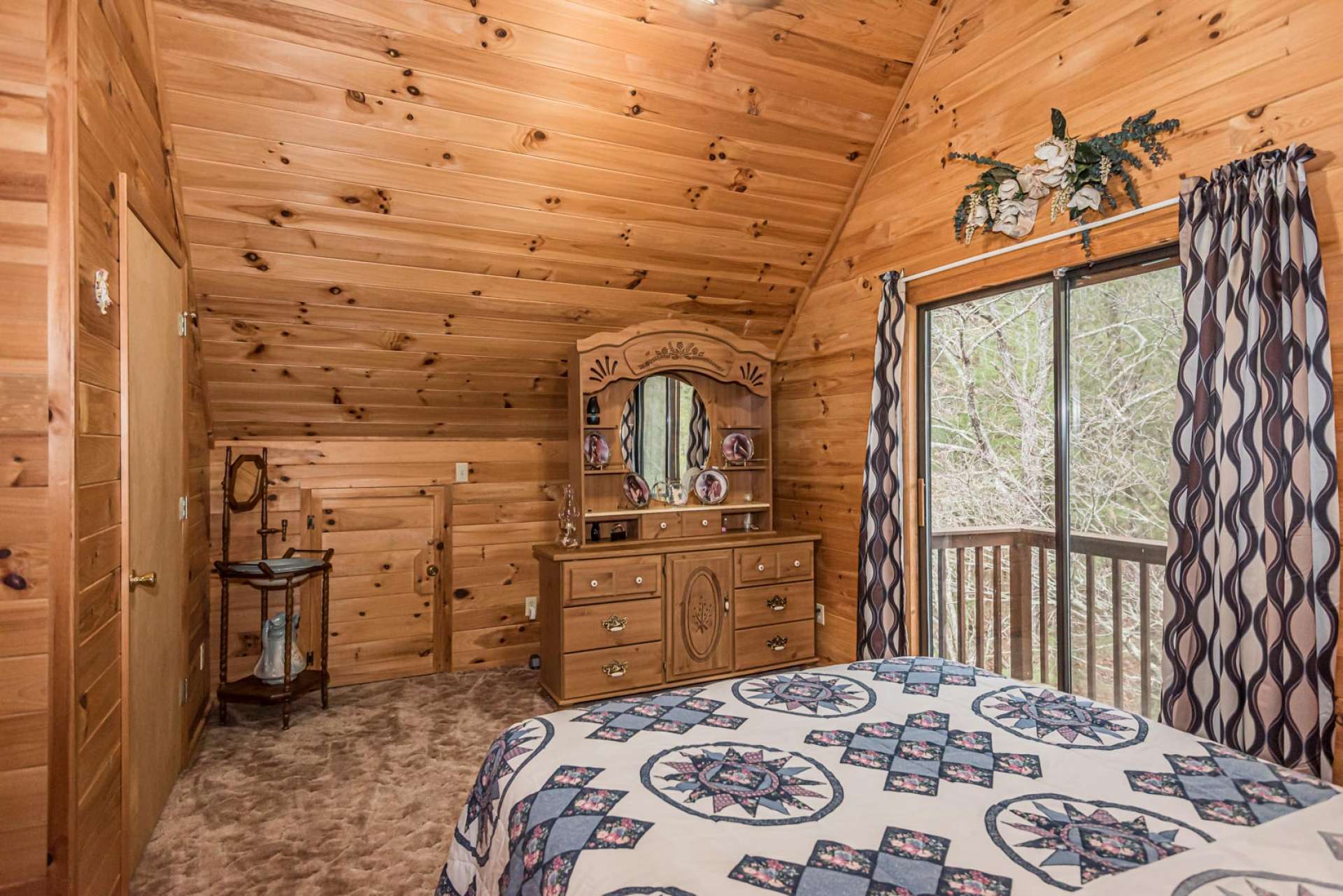 The upper level features a vaulted guest bedroom, full bath, and a vaulted bonus room currently utilized as additional sleeping space. The upper level bedroom also features a private balcony to enjoy Nature and the mountain scenery.