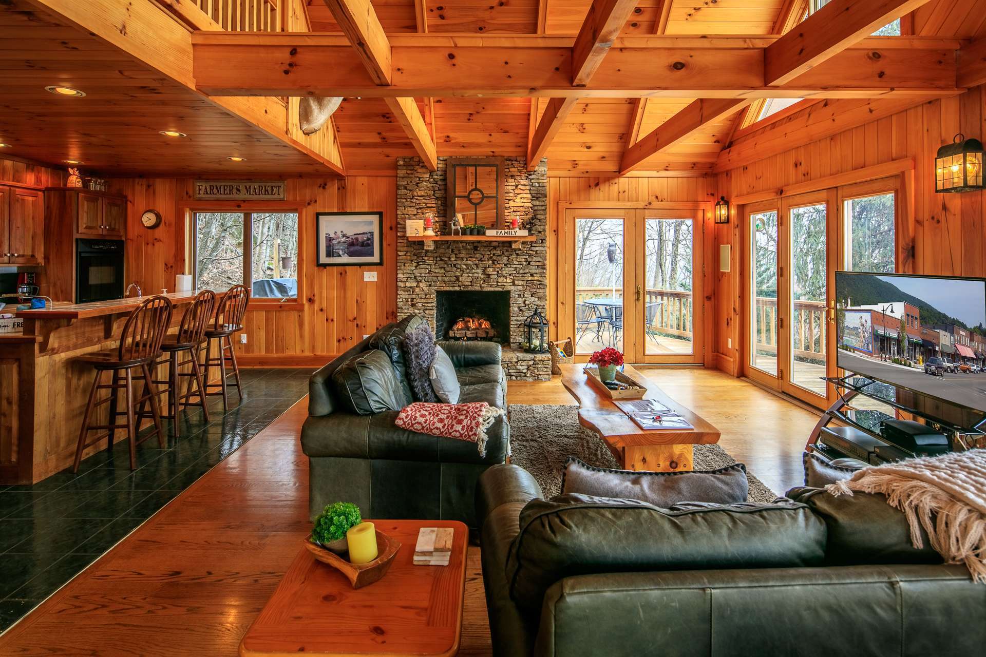 The hub of the home is found in the large vaulted great room with  stone fireplace and a wall of windows filling the room with natural light and allowing you to enjoy breathtaking views through all four seasons in the NC Mountains.