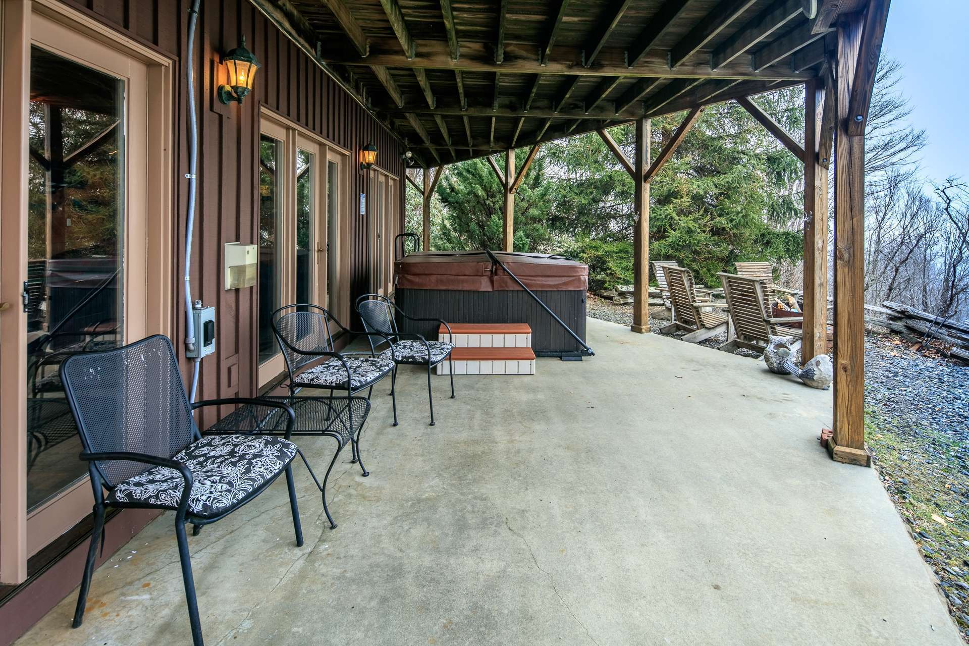 This lower level patio is access from the living area and offers another private place to relax in the hot tub while  enjoying the views.