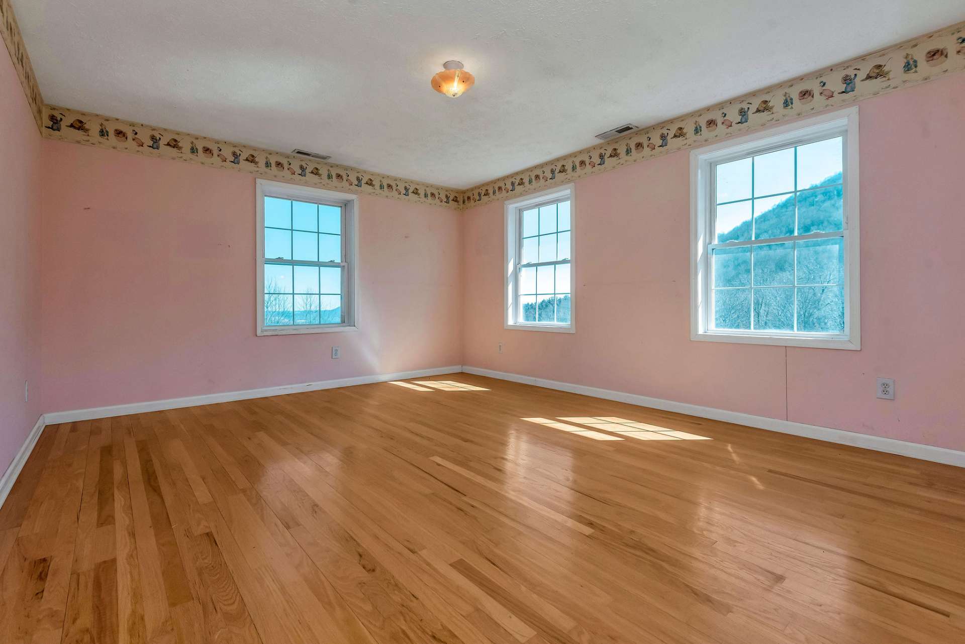 This guest room offers natural light and mountain views.