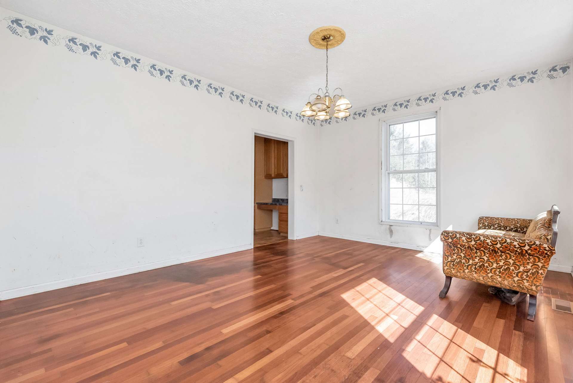 The formal dining area is to the right of the foyer and leads to the kitchen.