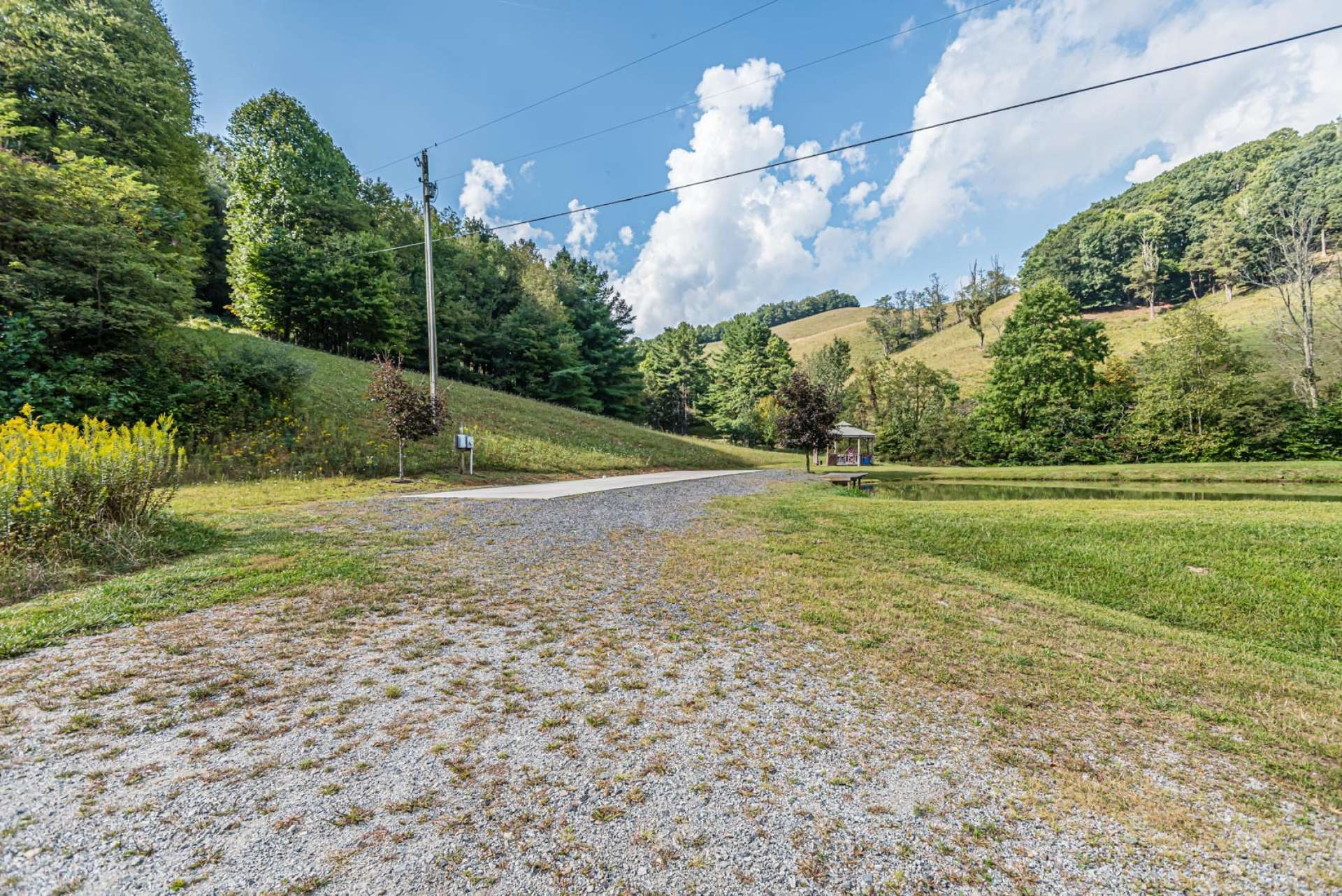 This property offers multiple springs and streams. There is a stocked creek fed pond with an adjacent 50 amp full camper hook-up with septic and water. What a great place to enjoy an afternoon picnic with friends and family sharing memories and fishing.