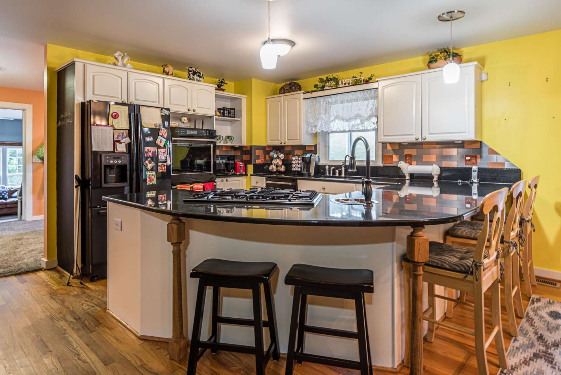 A fully equipped step saving kitchen offers granite countertops, plenty of work and storage space, and bar seating.