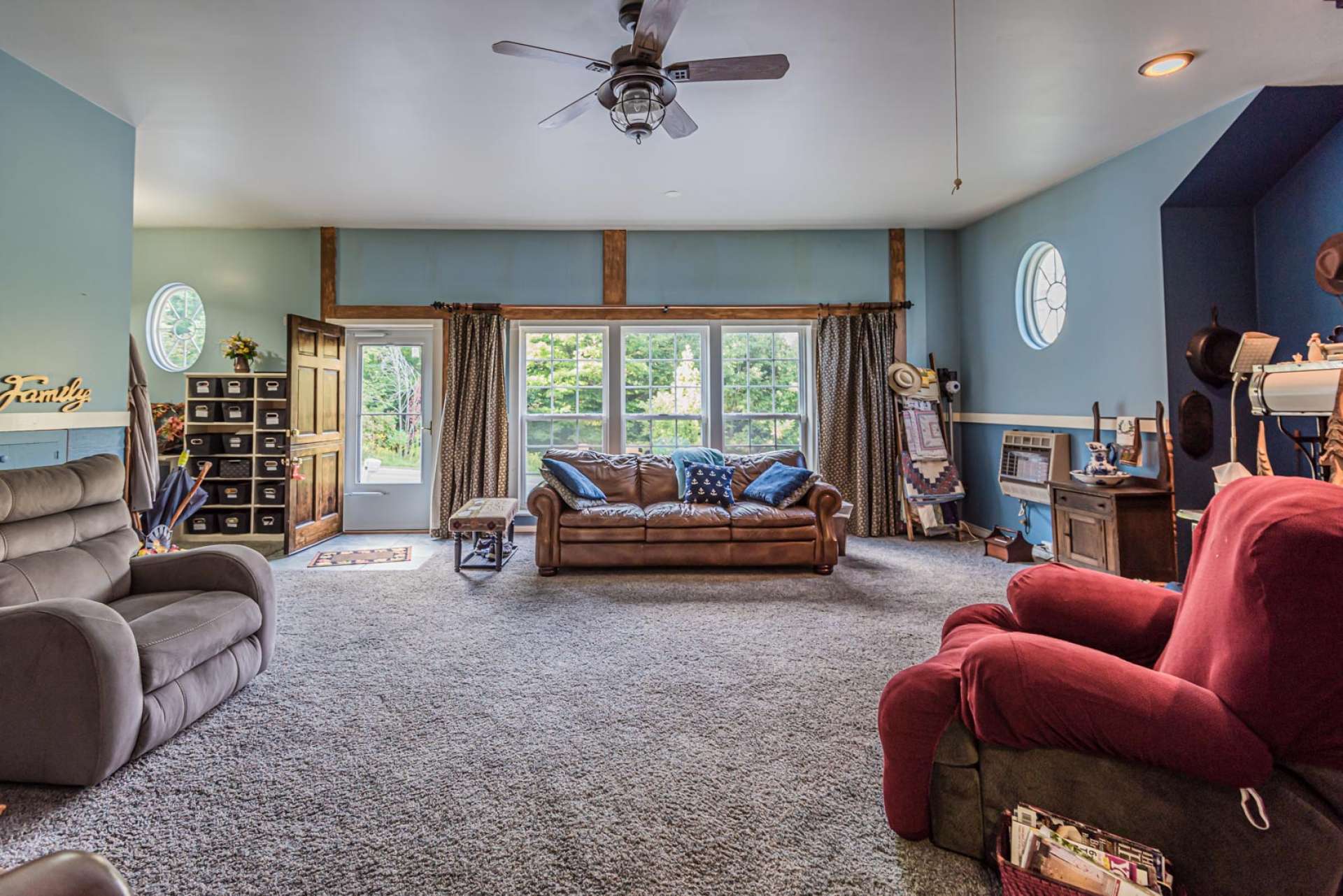 This large den area provides plenty of room to relax with family. Also notice the large windows and easy access to the outdoors.