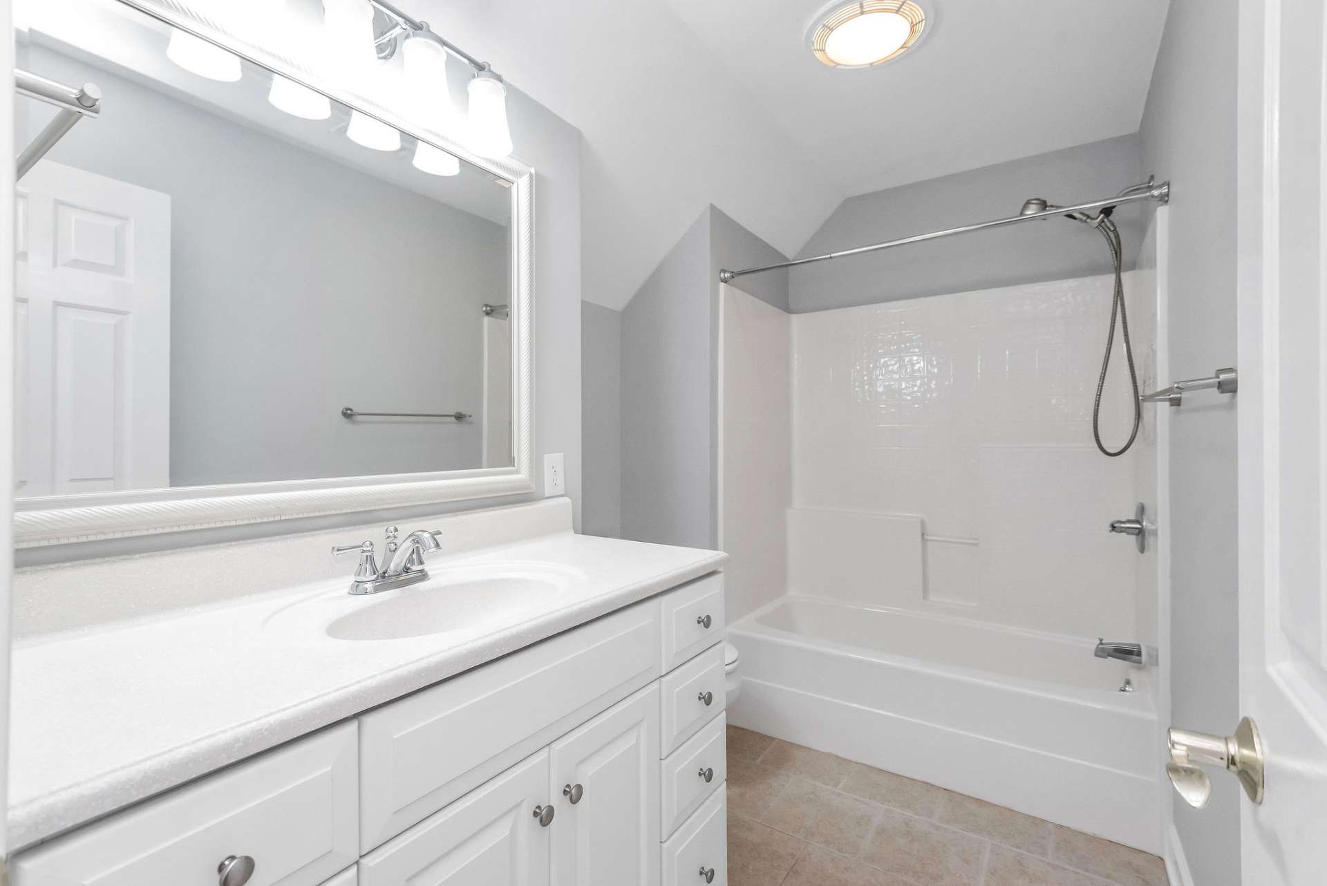 Upper level bedrooms 2 & 3 share this full bath which offers a ceramic tile floor and a fiberglass tub/shower combination, providing a convenient and versatile bathing option for residents and guests alike.