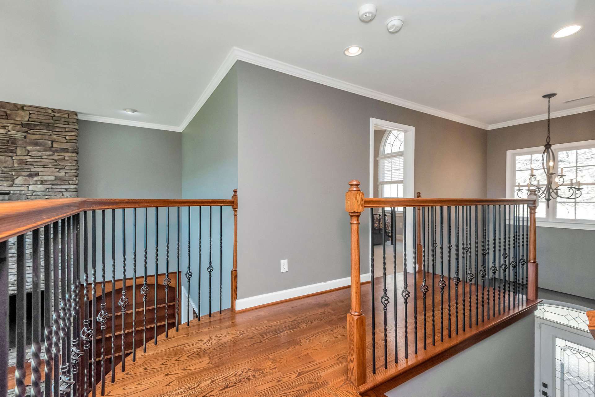 The balcony leads to upper-level bedrooms creating a sense of connection and continuity throughout the home.