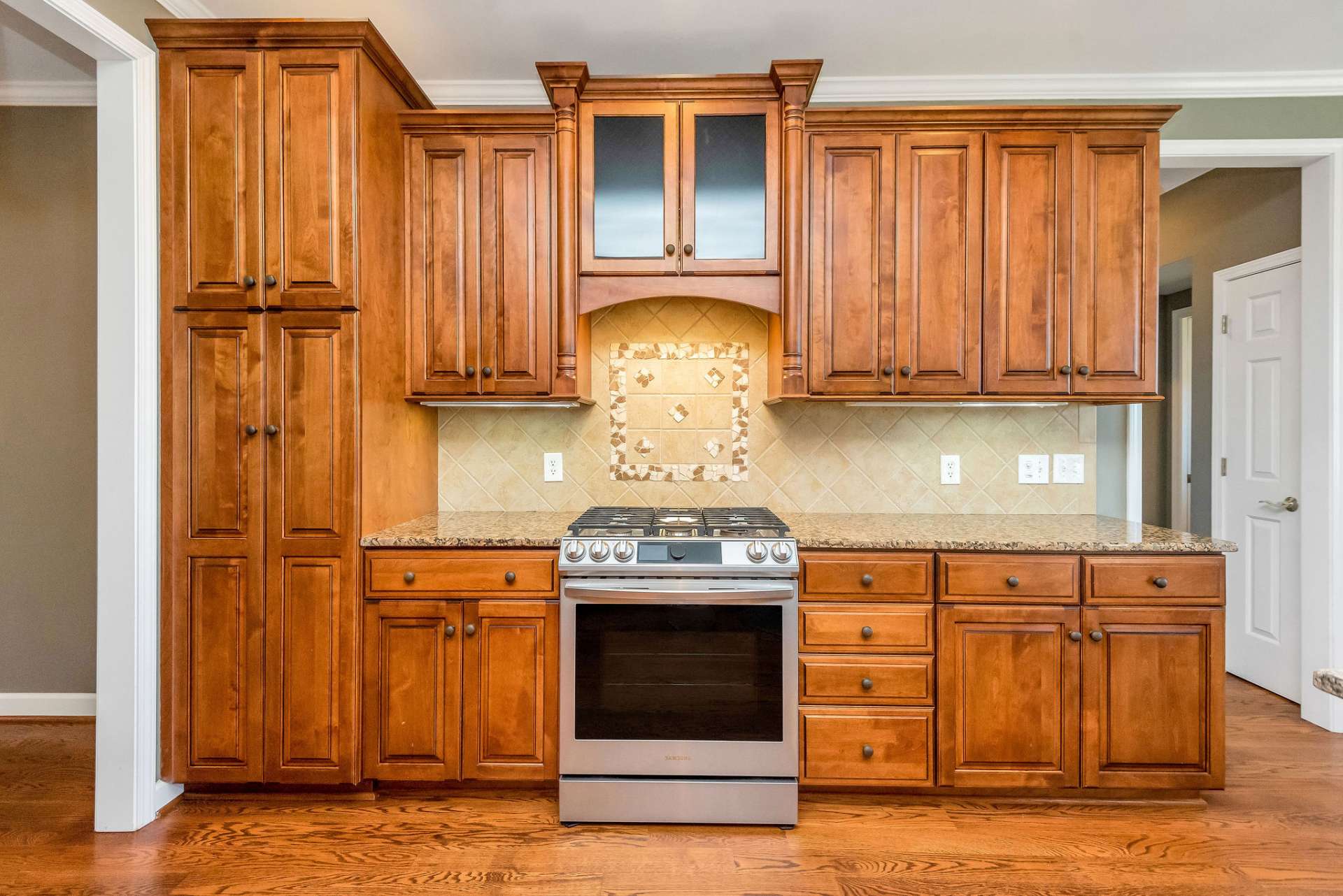 With its blend of cherry cabinetry, granite countertops, and stainless steel appliances, this kitchen is more than just a place to cook—it's a stylish and functional space where culinary dreams come to life, and cherished memories are made around the table.