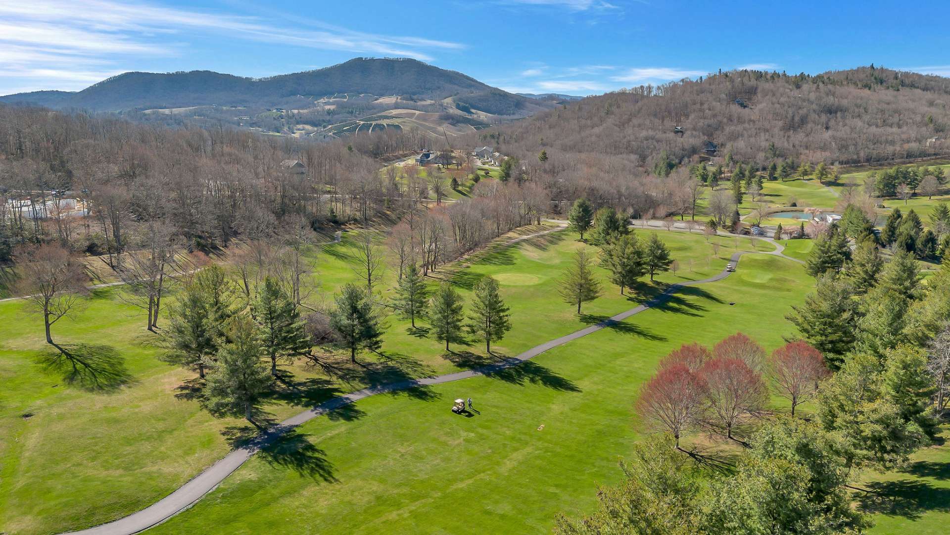 Picture yourself standing on the deck of your dream home nestled within the picturesque landscape of Mountain Aire Golf Course. As you gaze outwards, Fairway #5 unfolds beneath your eyes, a verdant ribbon winding its way through the meticulously manicured greenery.