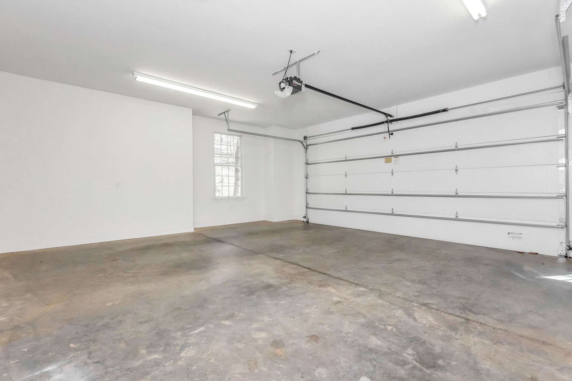 The main level 2-car garage offers ample room to comfortably park two vehicles side by side, providing convenience and protection from the elements. Plenty of space to add shelving and/or cabinets.