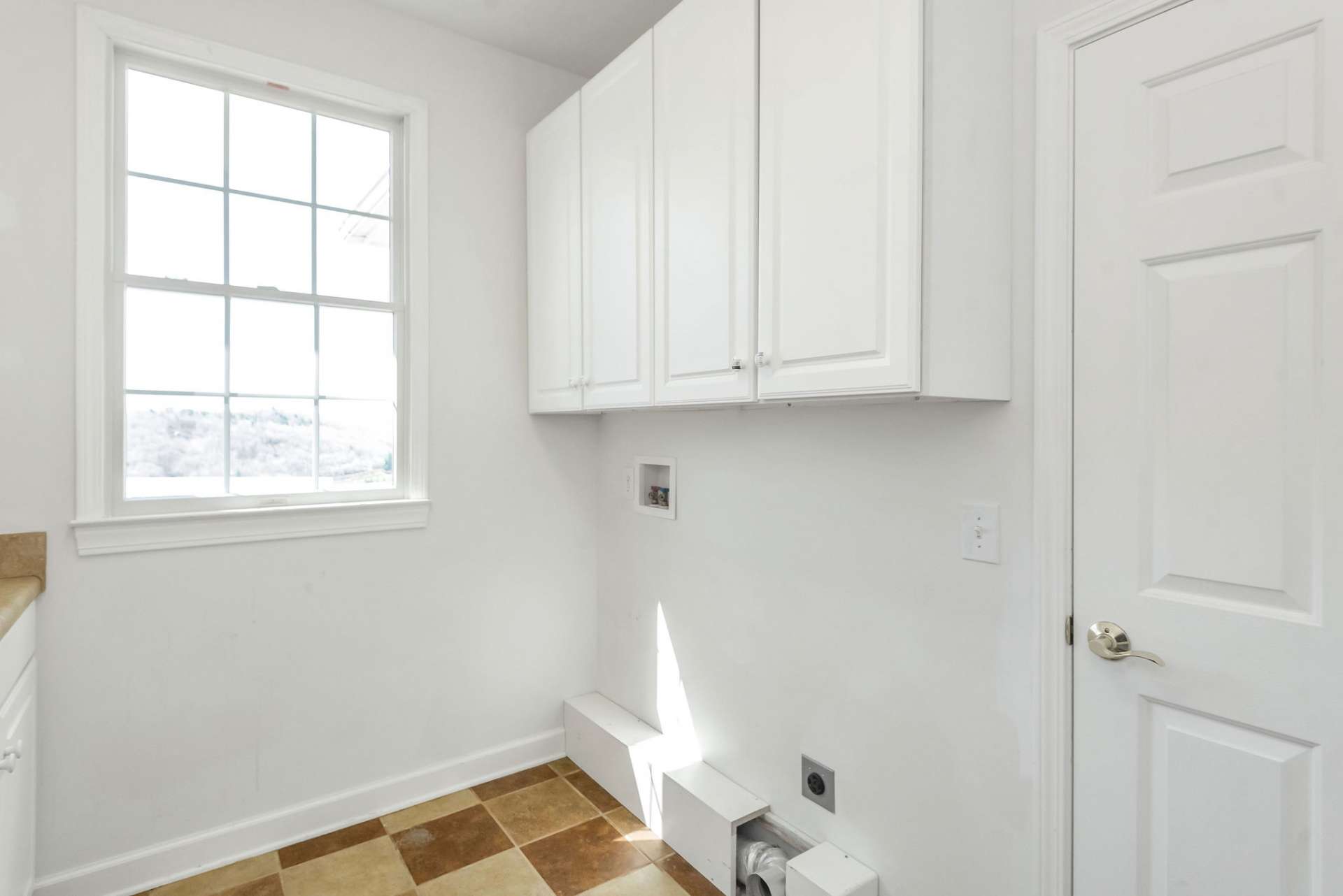 This laundry room is not just a practical necessity but also a stylish and efficient space that makes laundry day a little more enjoyable.