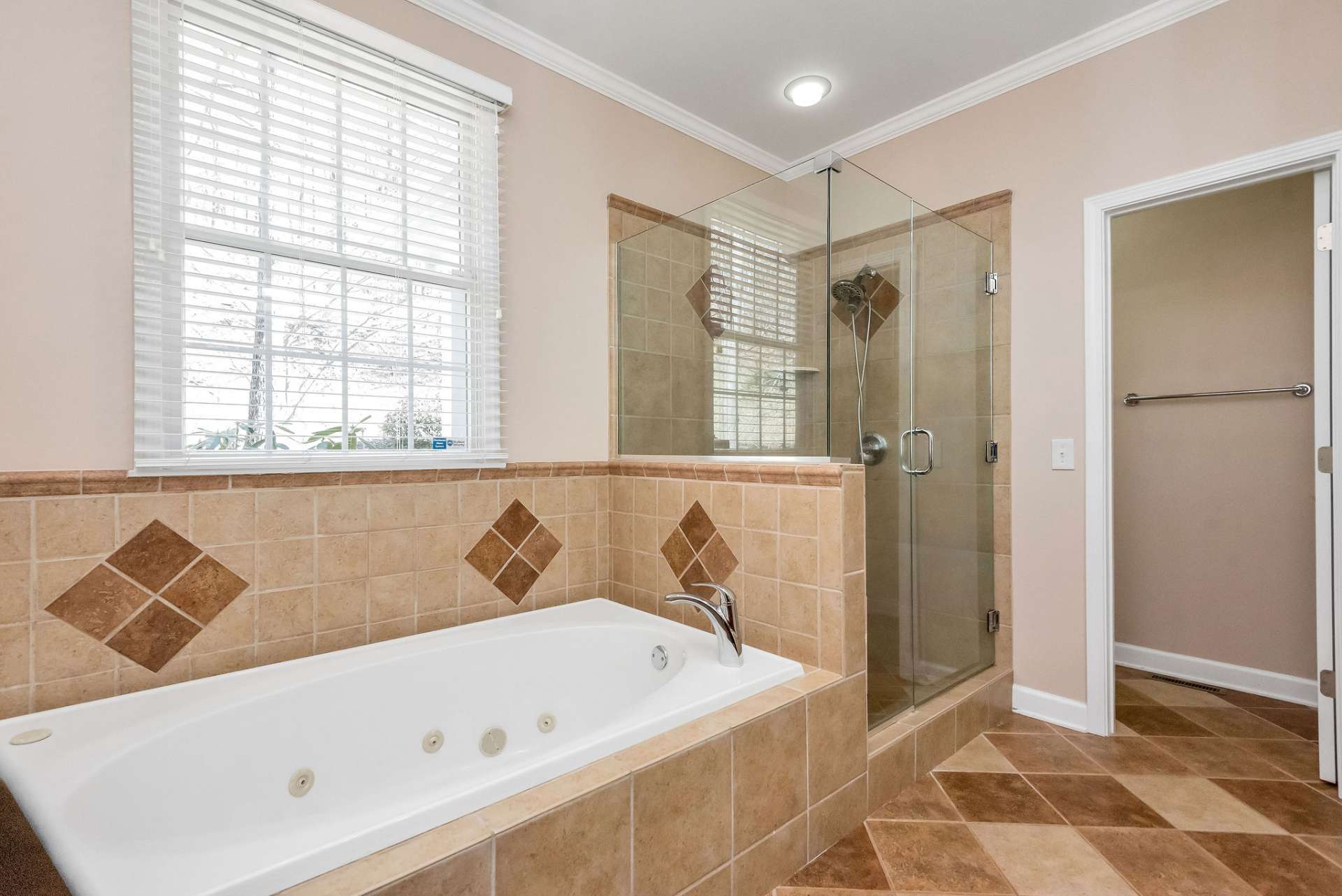 Enjoy luxury and comfort within the ensuite bath of your primary bedroom retreat which offers a whirlpool tub and a spacious tile shower. A water closet is tucked away for privacy.