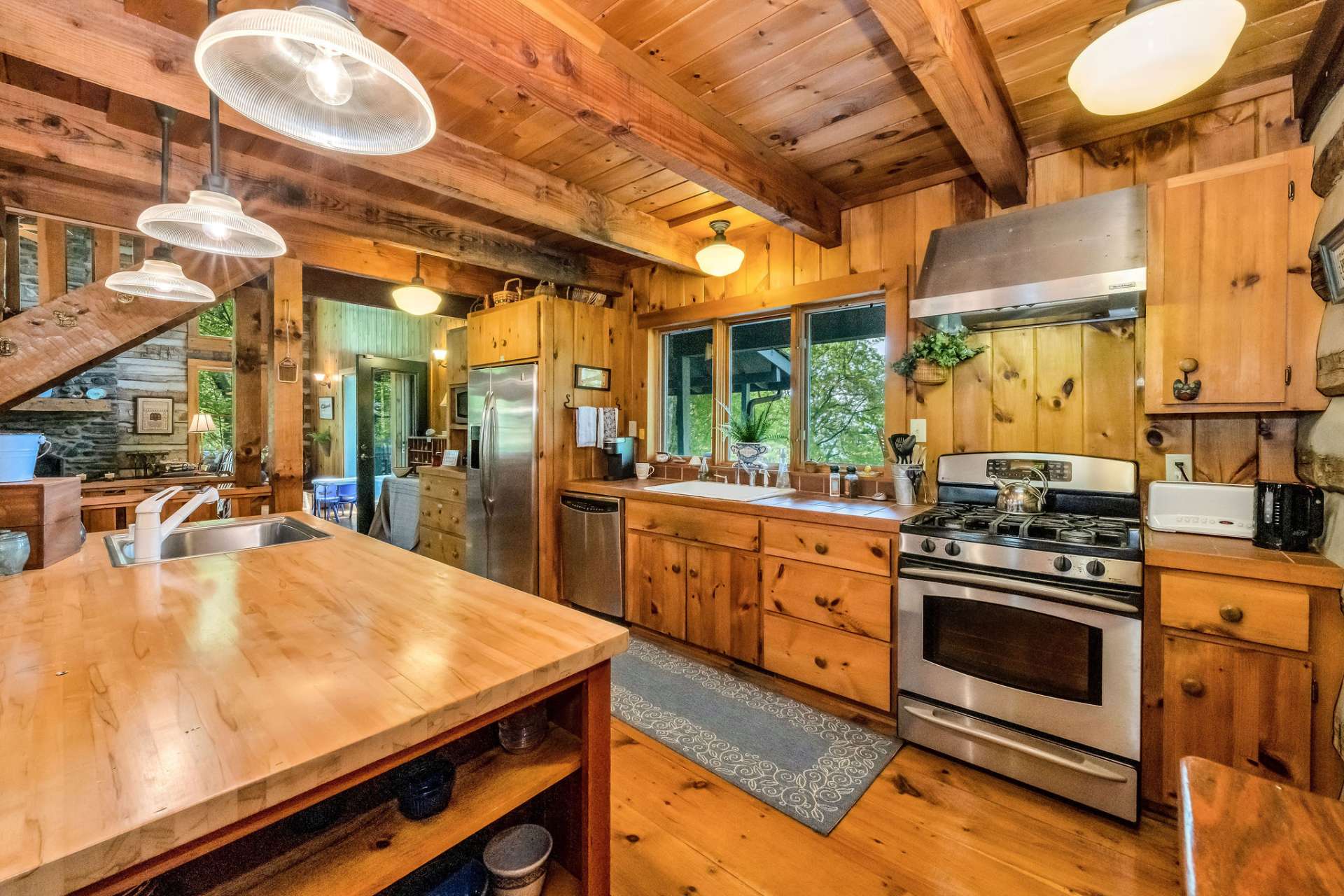 Gaze out at a boundless stretch of mountain crests framed by 3 large windows behind the farm sink.