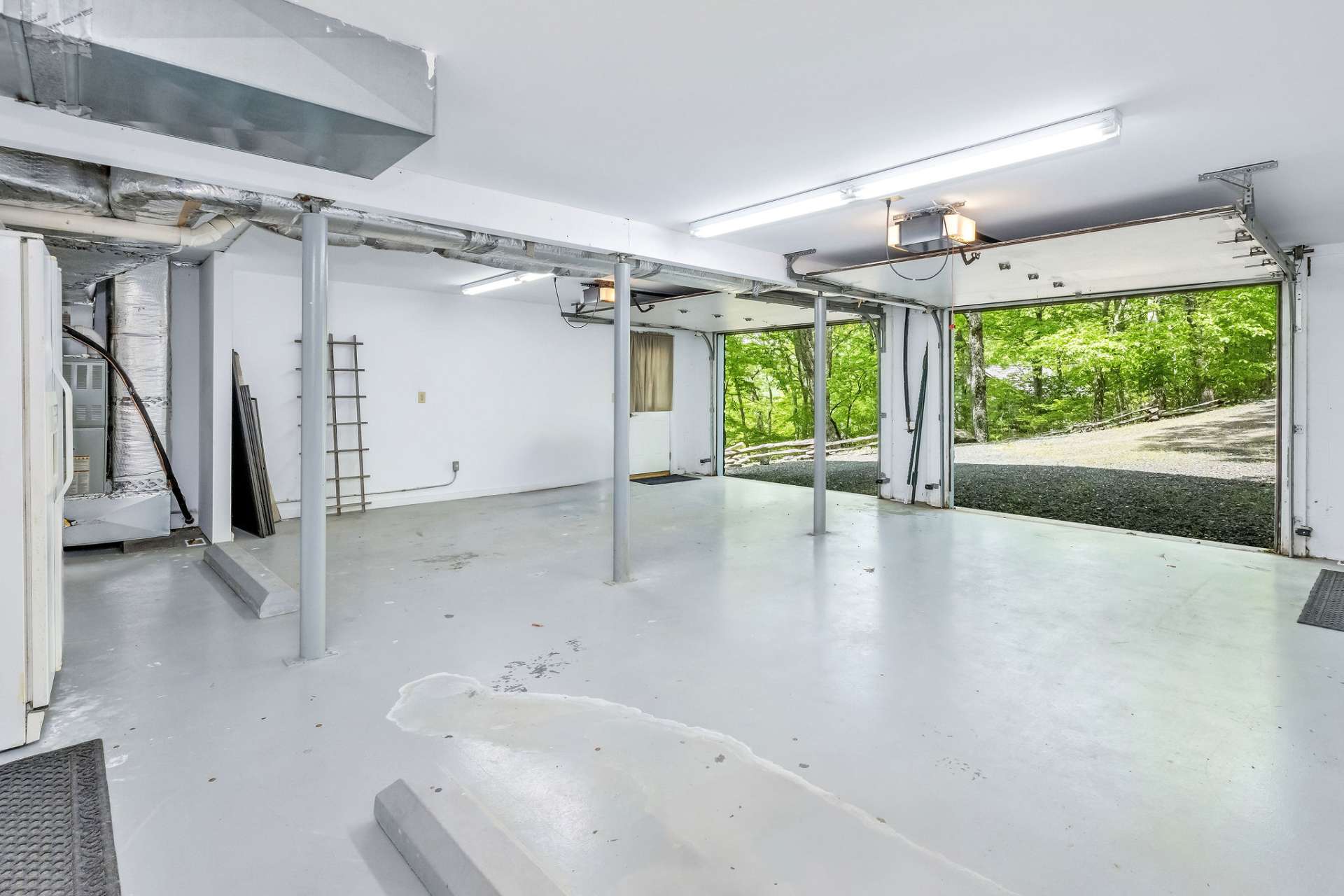 This 2 car garage is oversized and complete with a workbench.