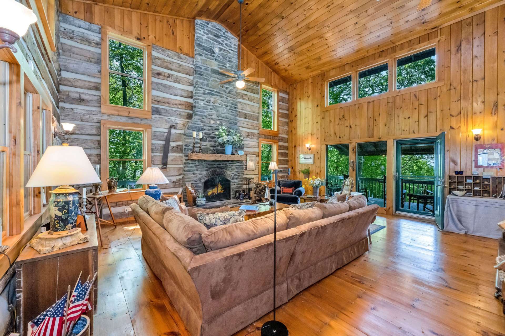 Step inside to a spacious great room where a soaring two-story stone fireplace commands attention and anchors the space with rustic elegance.