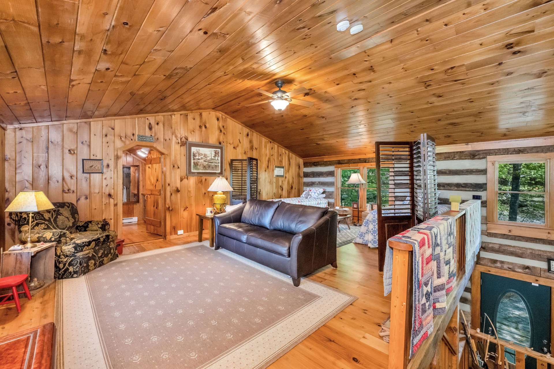 On the upper level, a spacious loft is currently used as a sitting room and additional sleeping.