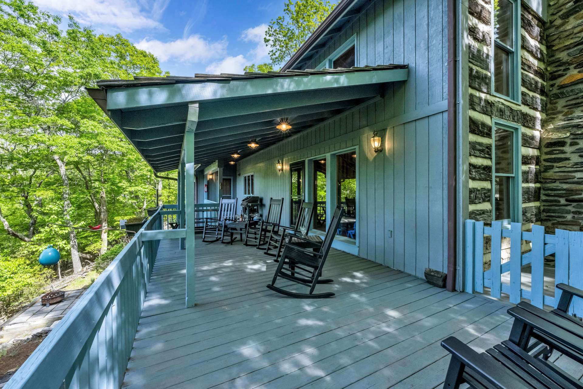 The back deck features covered and open spaces for relaxing and taking in the outdoor scenery.