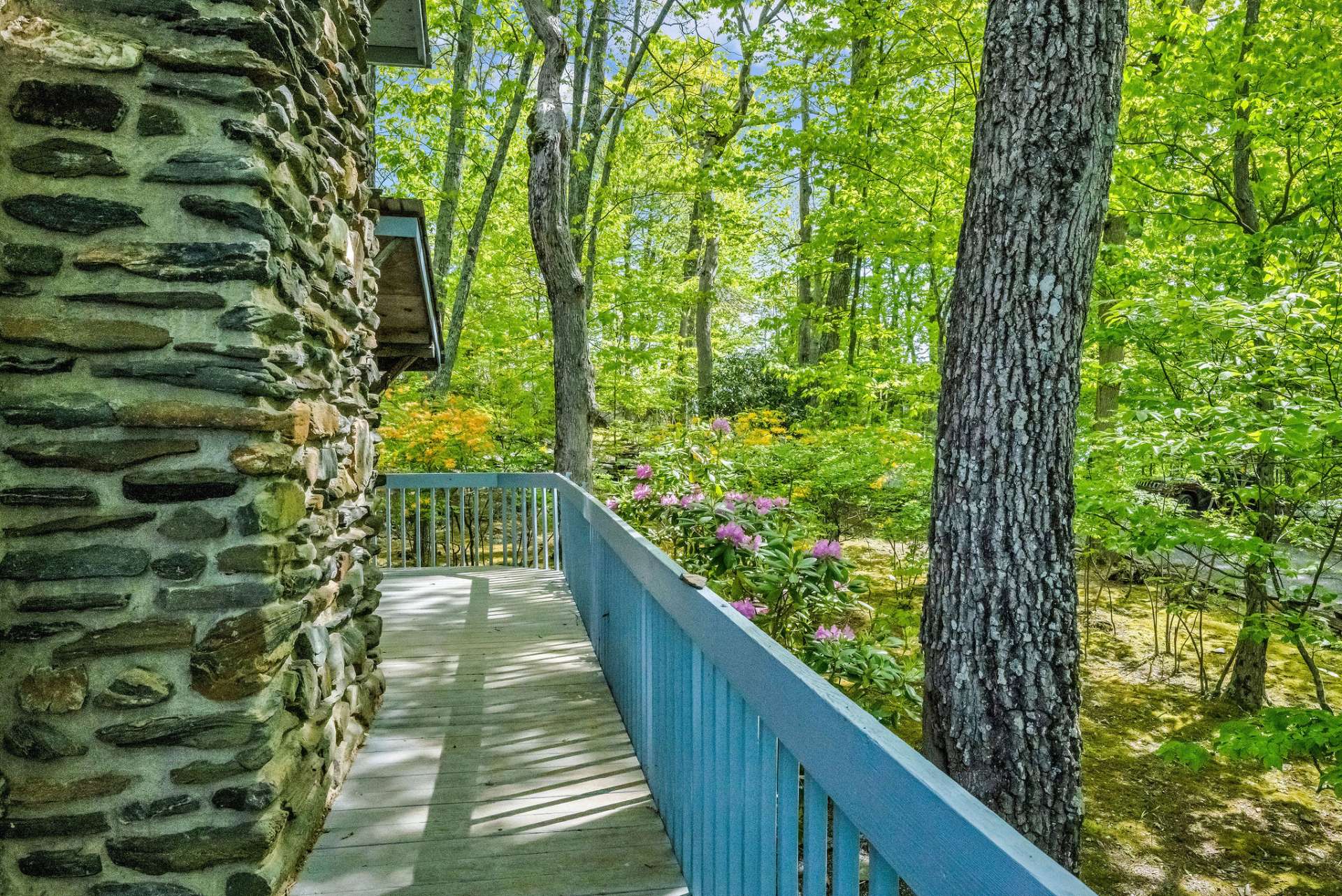 The deck wraps around to the front porch.