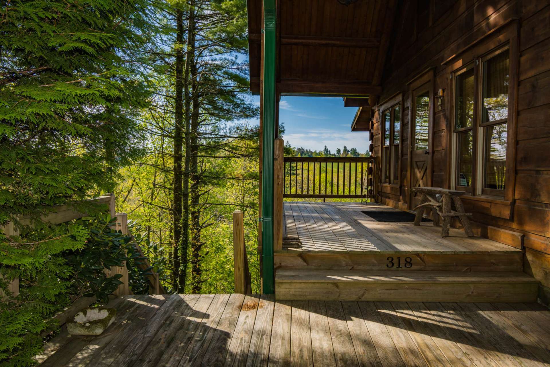 A covered front porch welcomes you and invites you to step inside for a true log cabin living experience with all of today's modern conveniences, after taking time to enjoy the views.