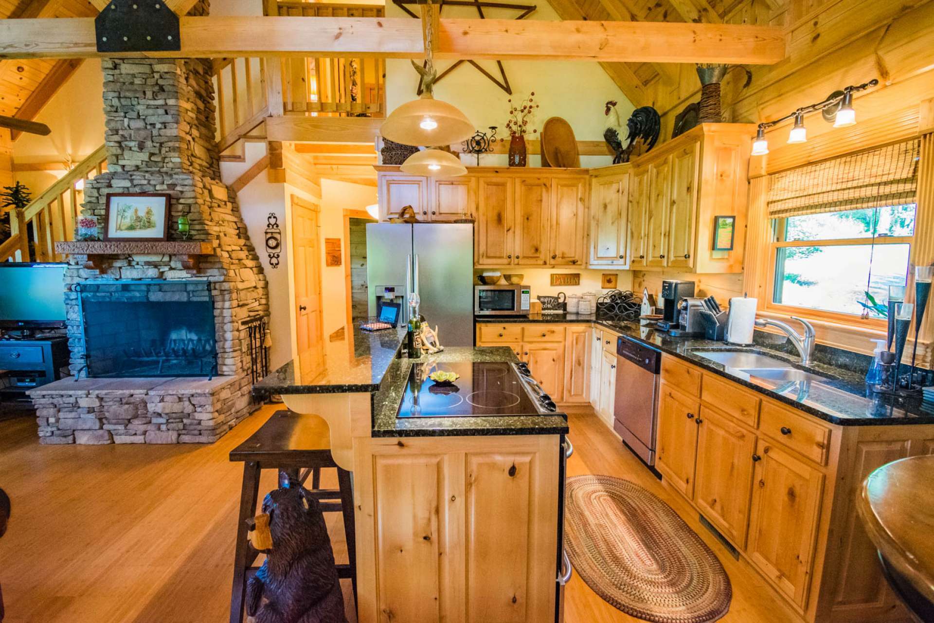 Just look at all the work and storage space in this beautiful kitchen featuring granite countertops, stainless appliances, and a center island with seating for informal dining.