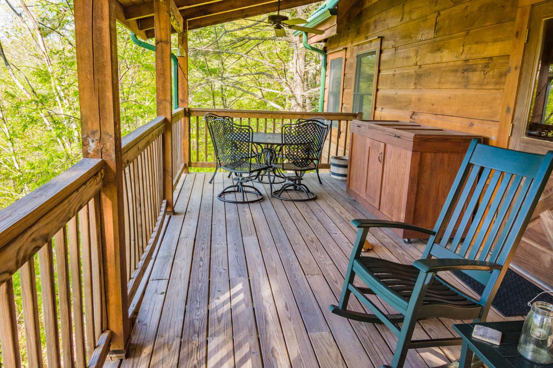 The main level covered deck offers a relaxing space for outdoor dining.