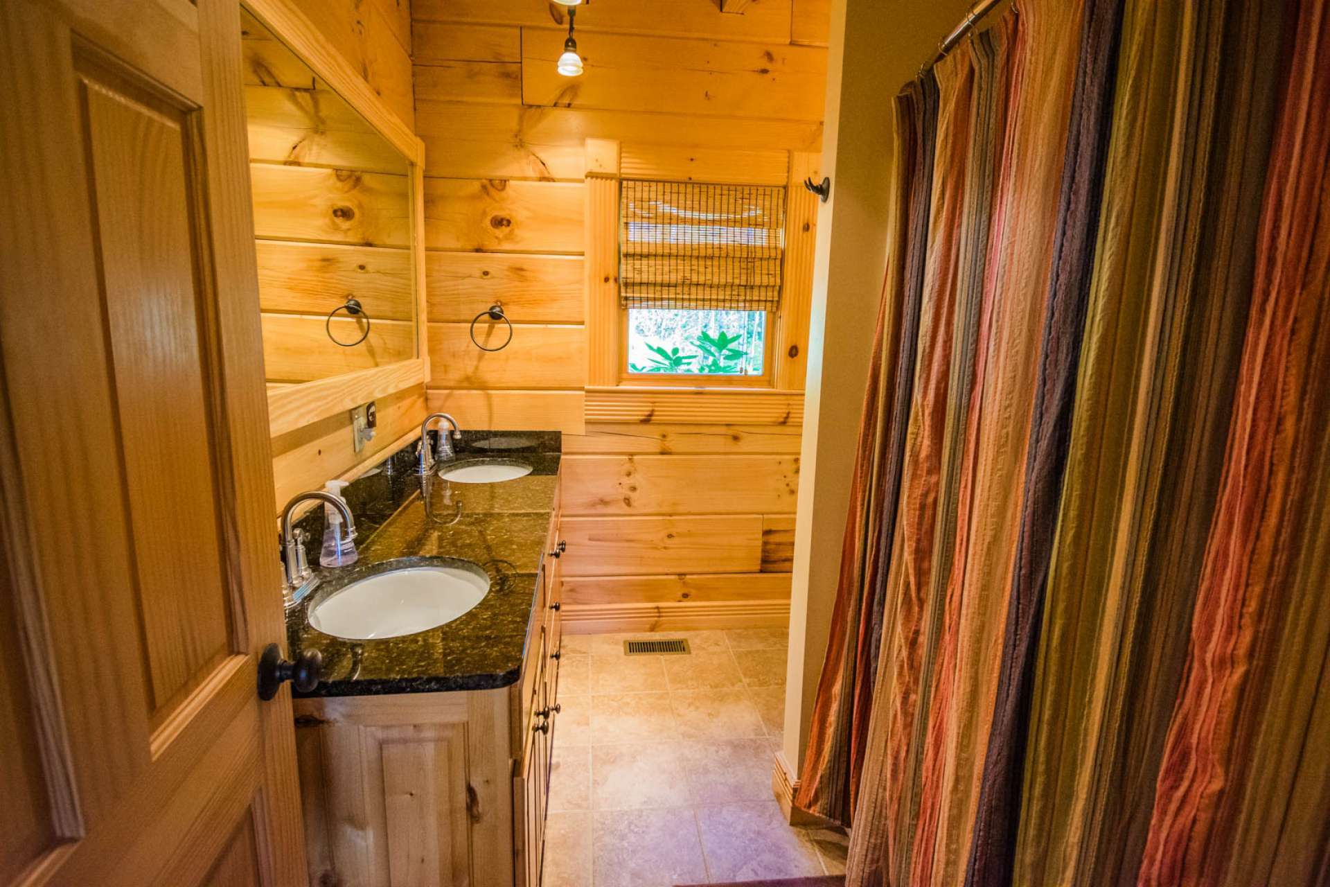 The master bath features a double vanity with granite countertop, and ceramic tile floor.