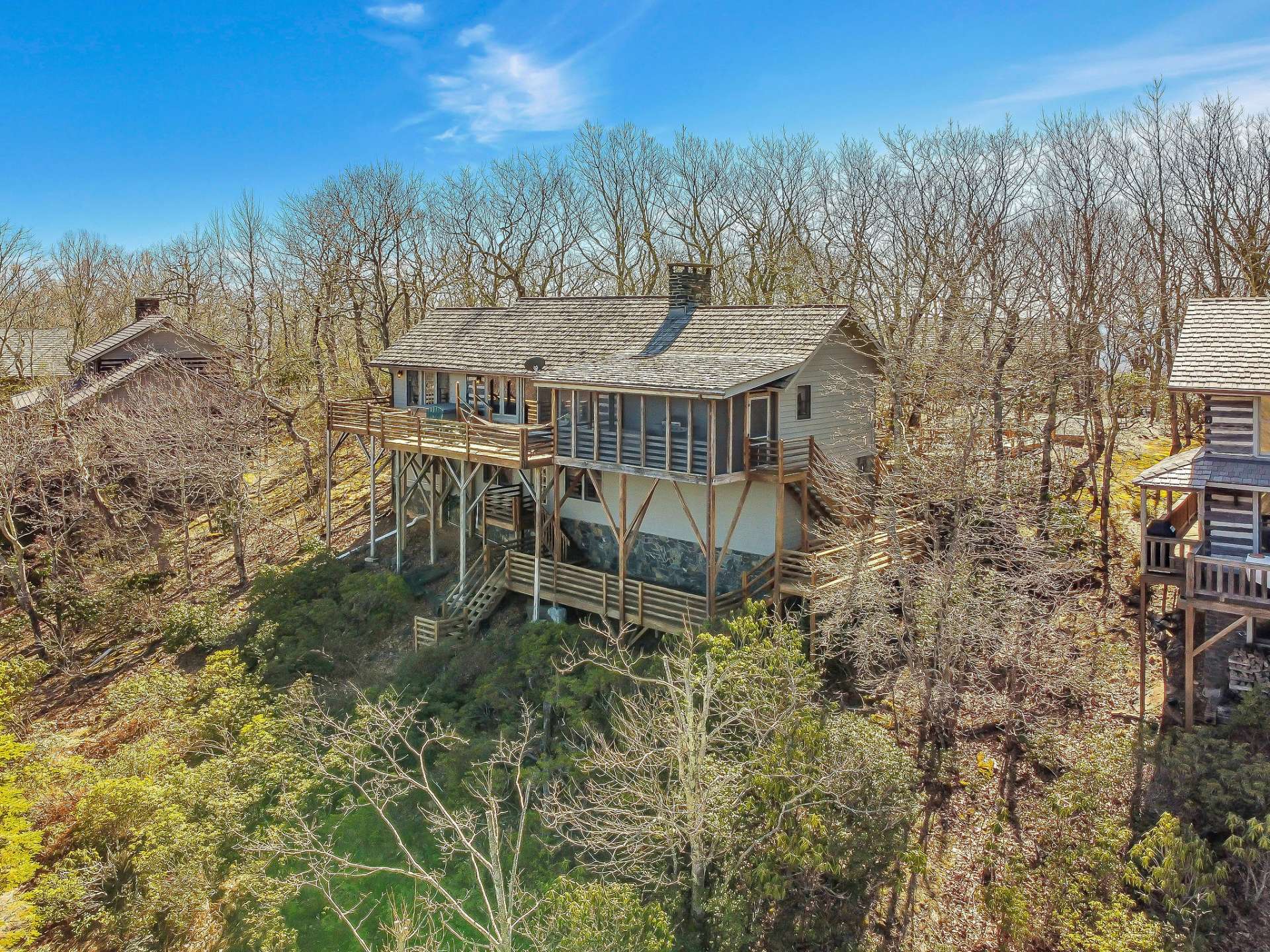 Welcome to your Blue Ridge Mountain log cabin nestled in a natural setting with views in the highly sought-after log cabin community of Stonebridge in the Southern Ashe County area of the NC High Country.