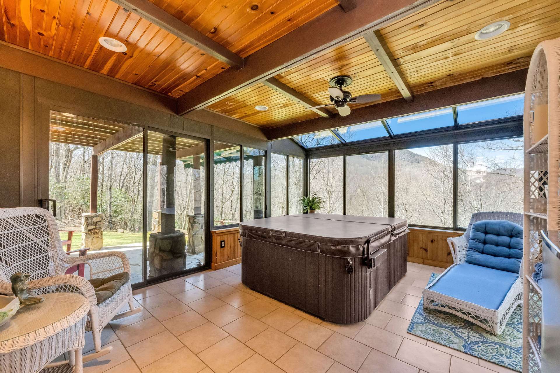 Lower level sunroom with hot tub and outdoor patio.