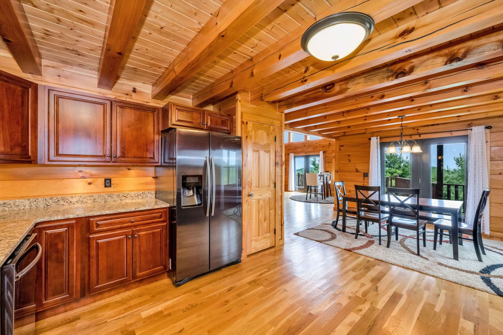 Outfitted with sleek Samsung black stainless appliances, the kitchen combines modern function with classic mountain style.