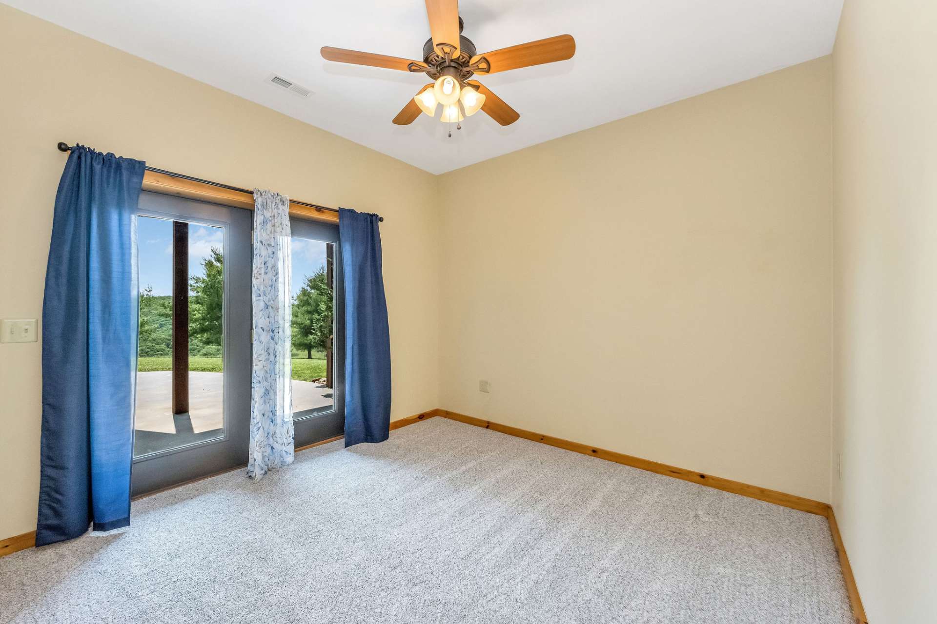 This cozy, carpeted room offers versatile space and plenty of natural light.