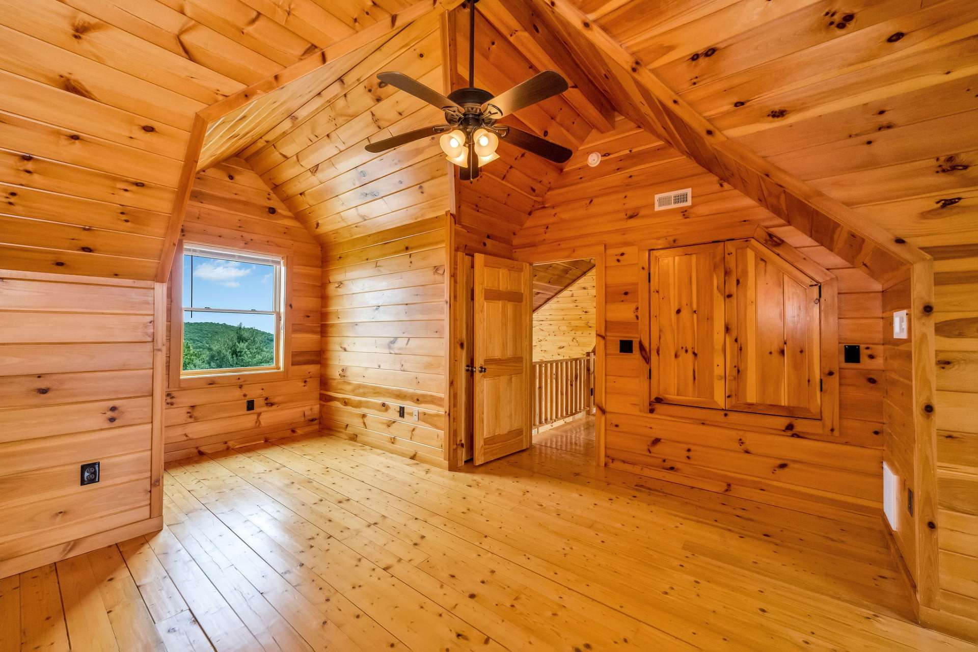 Clad in the same warm pine as the adjacent bedroom, this room also offers a warm and inviting atmosphere with flexible space for guests or everyday living.