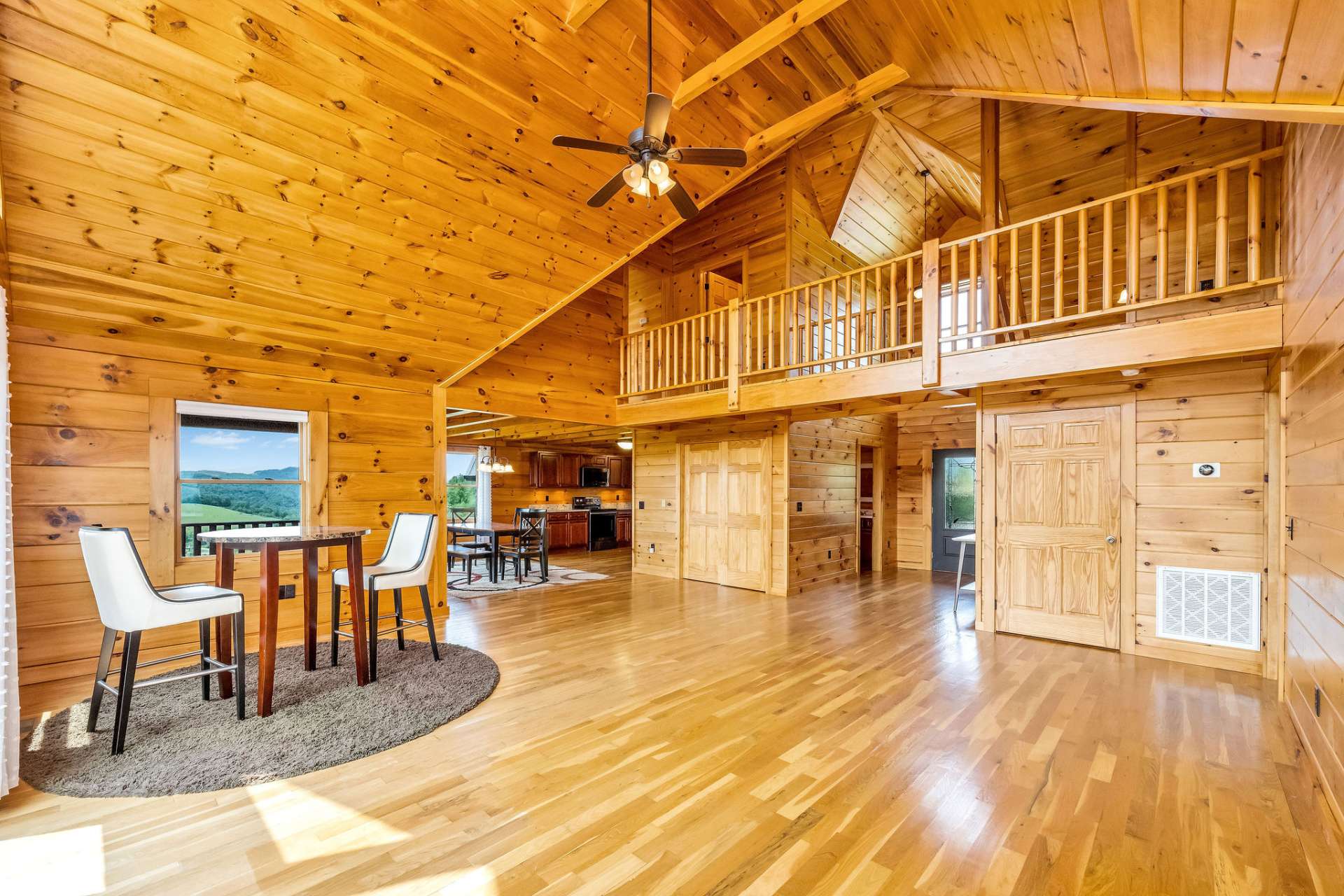 Showcasing unique architectural design, including exposed beams and this striking open hallway on the second level that connects the bedrooms.