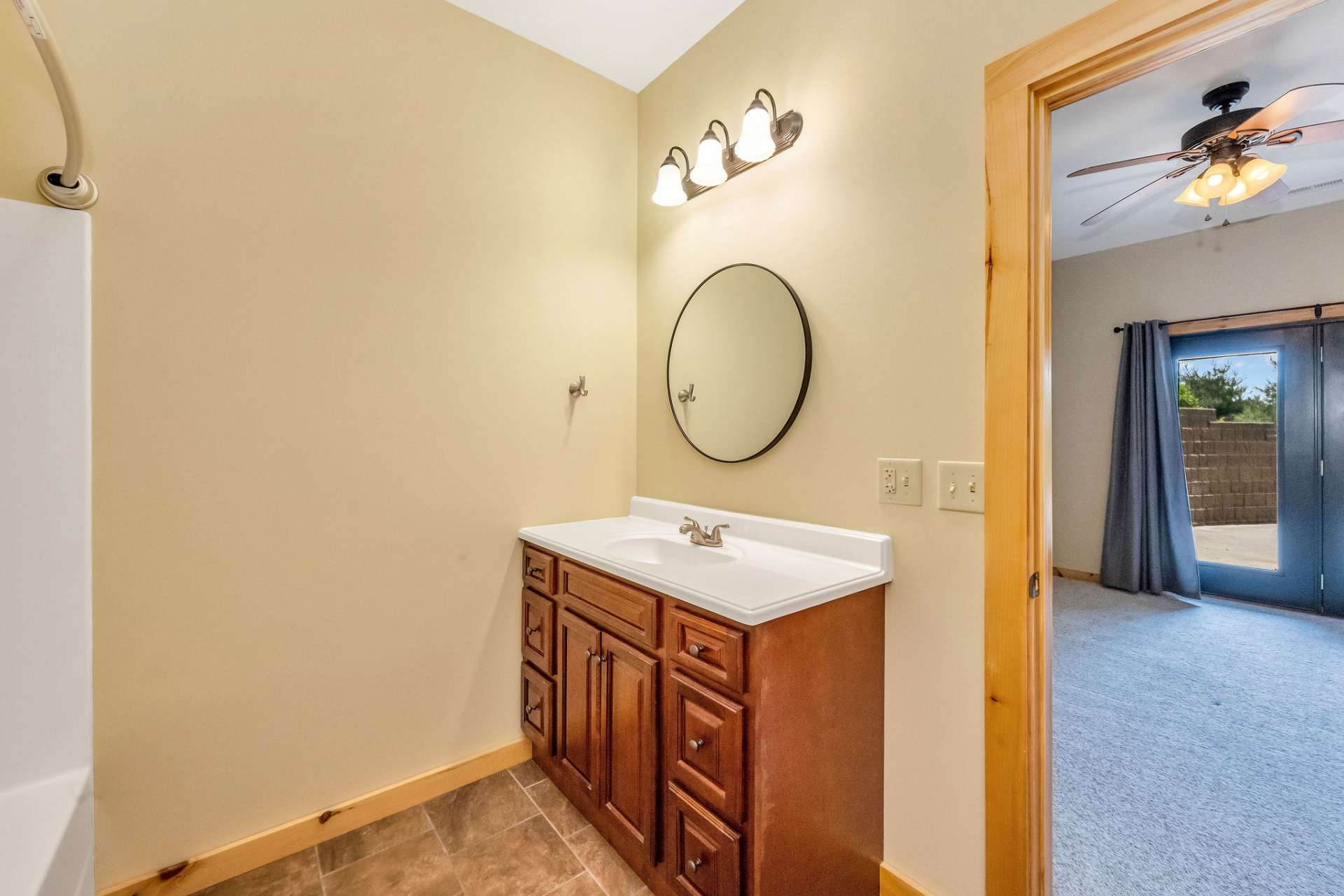 Enjoy the rich cherry vanity paired with a practical fiberglass tub/shower combo—functional style at its best.