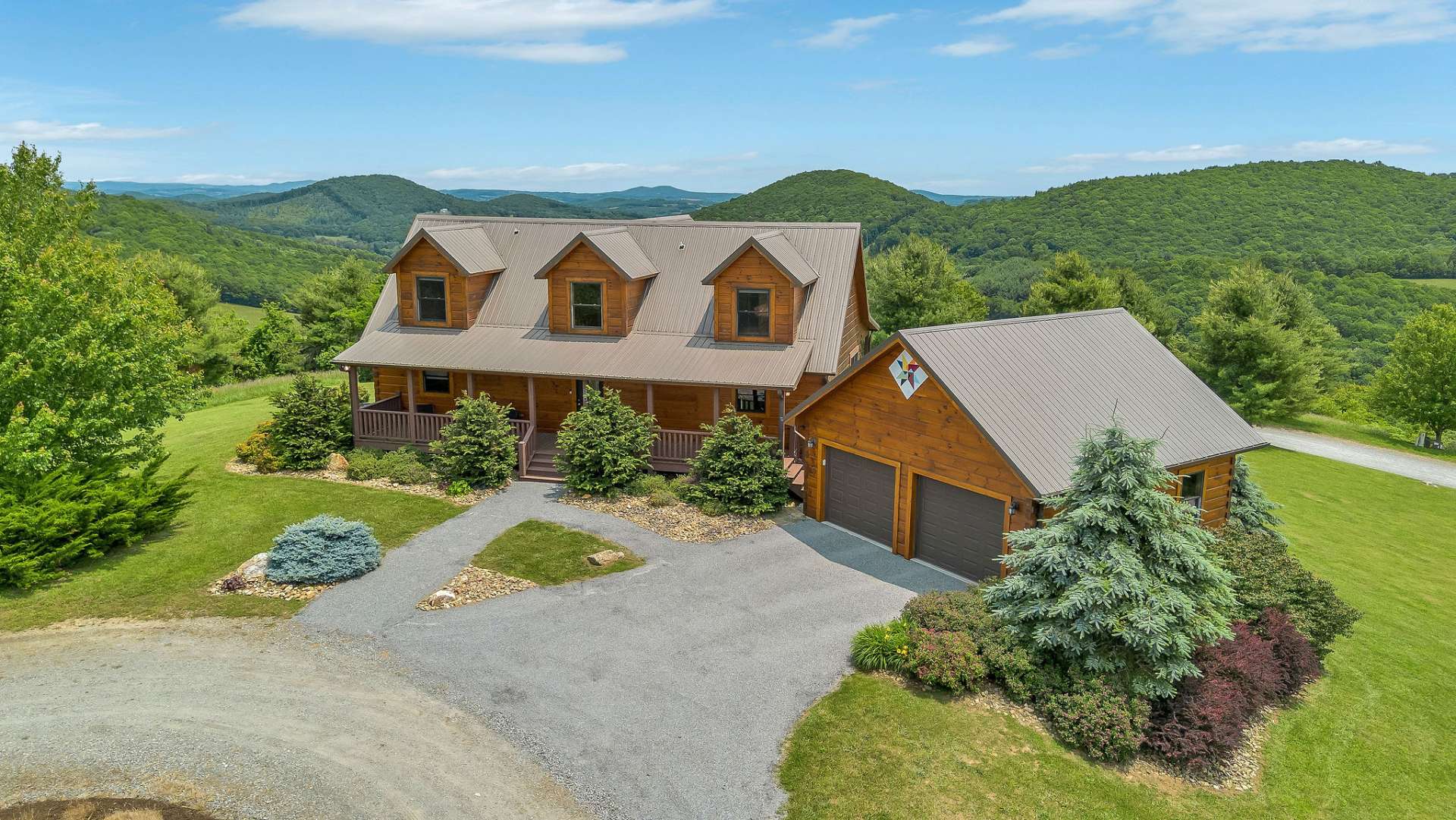 Classic mountain appeal with a covered front porch and detached garage for added storage and functionality.