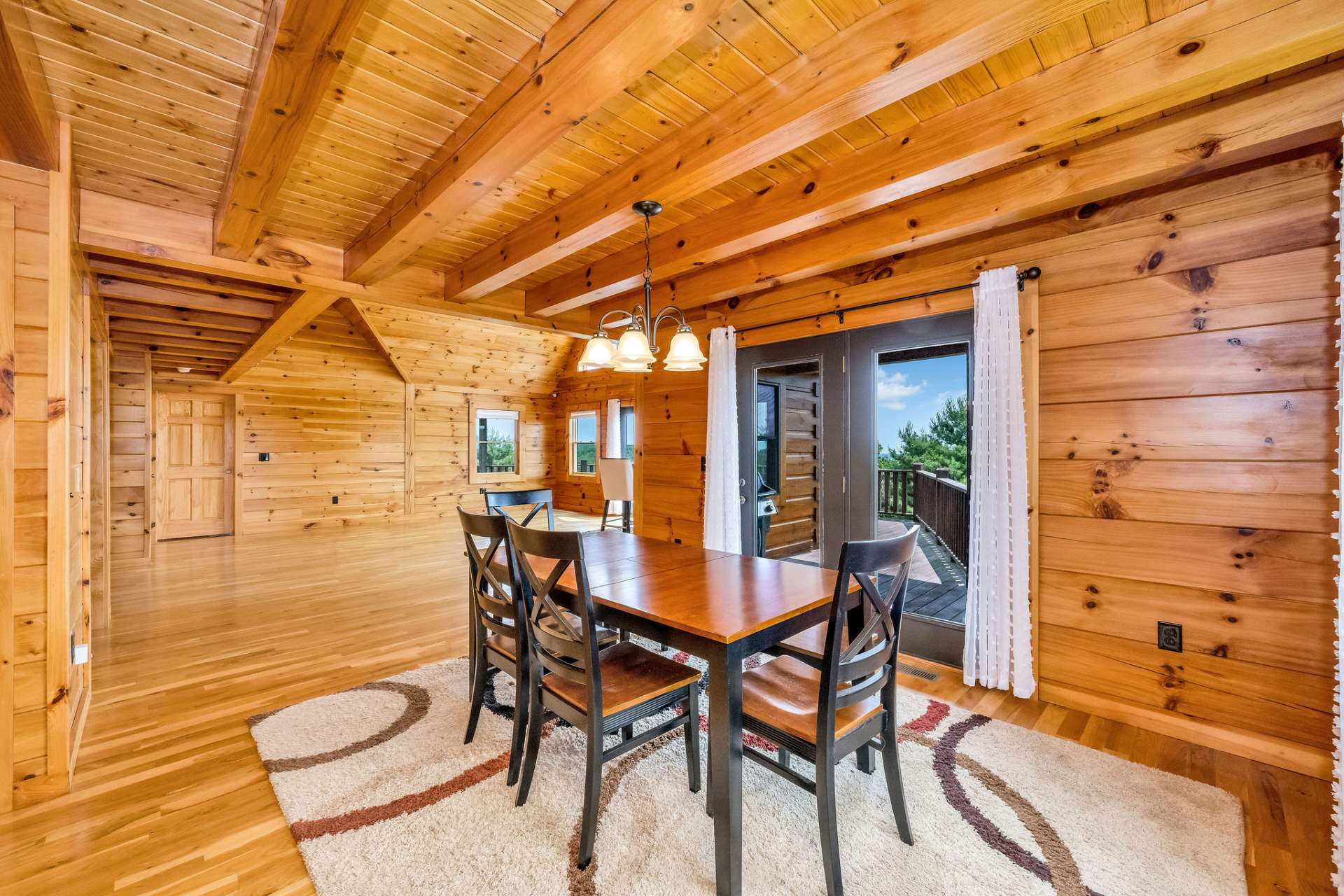 Glass doors off the dining area open to the rear deck, making outdoor grilling and dining easily accessible. Grill included!