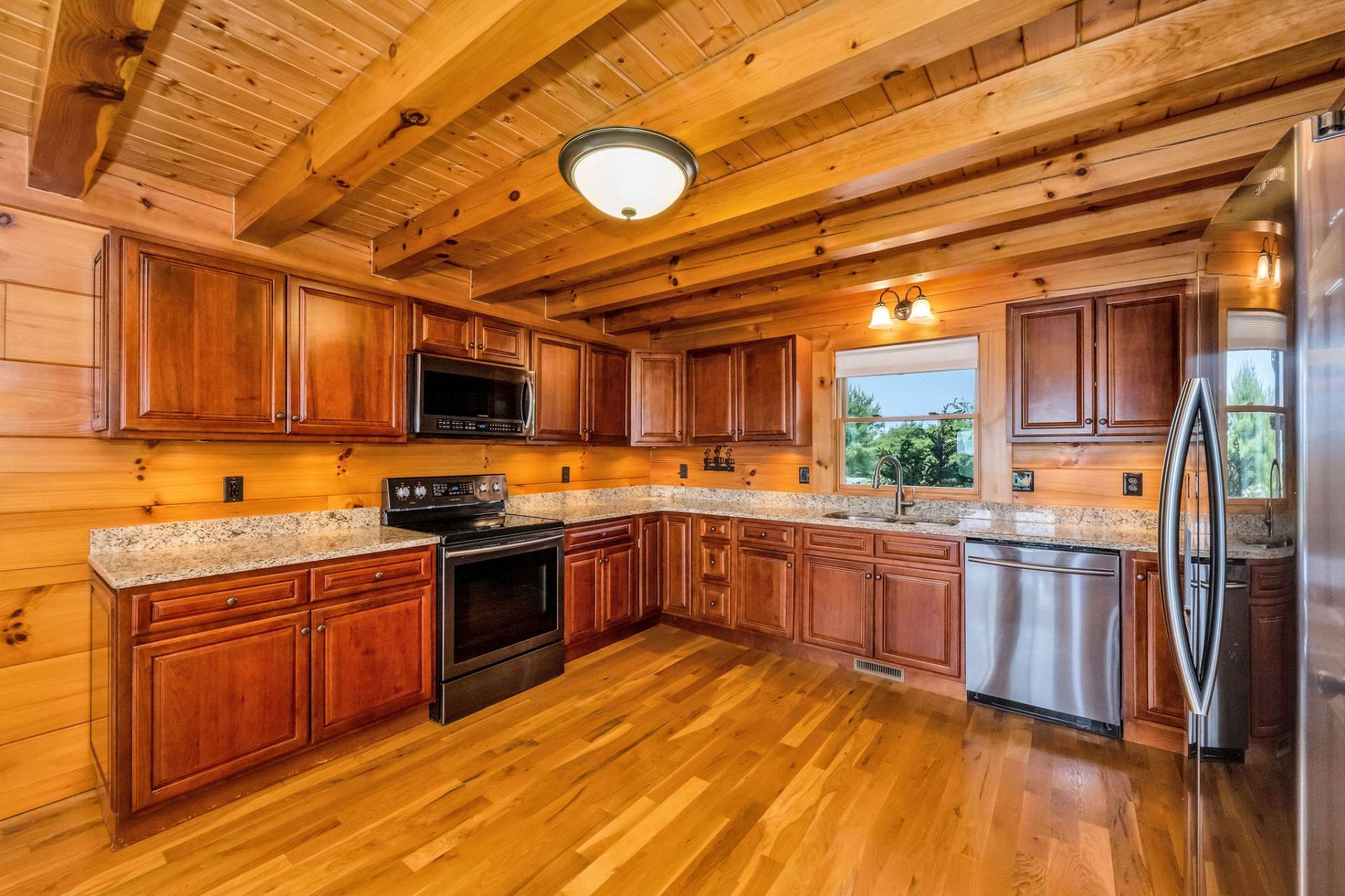 The kitchen showcases rich, abundant cherry cabinetry that offers both beauty and generous storage.