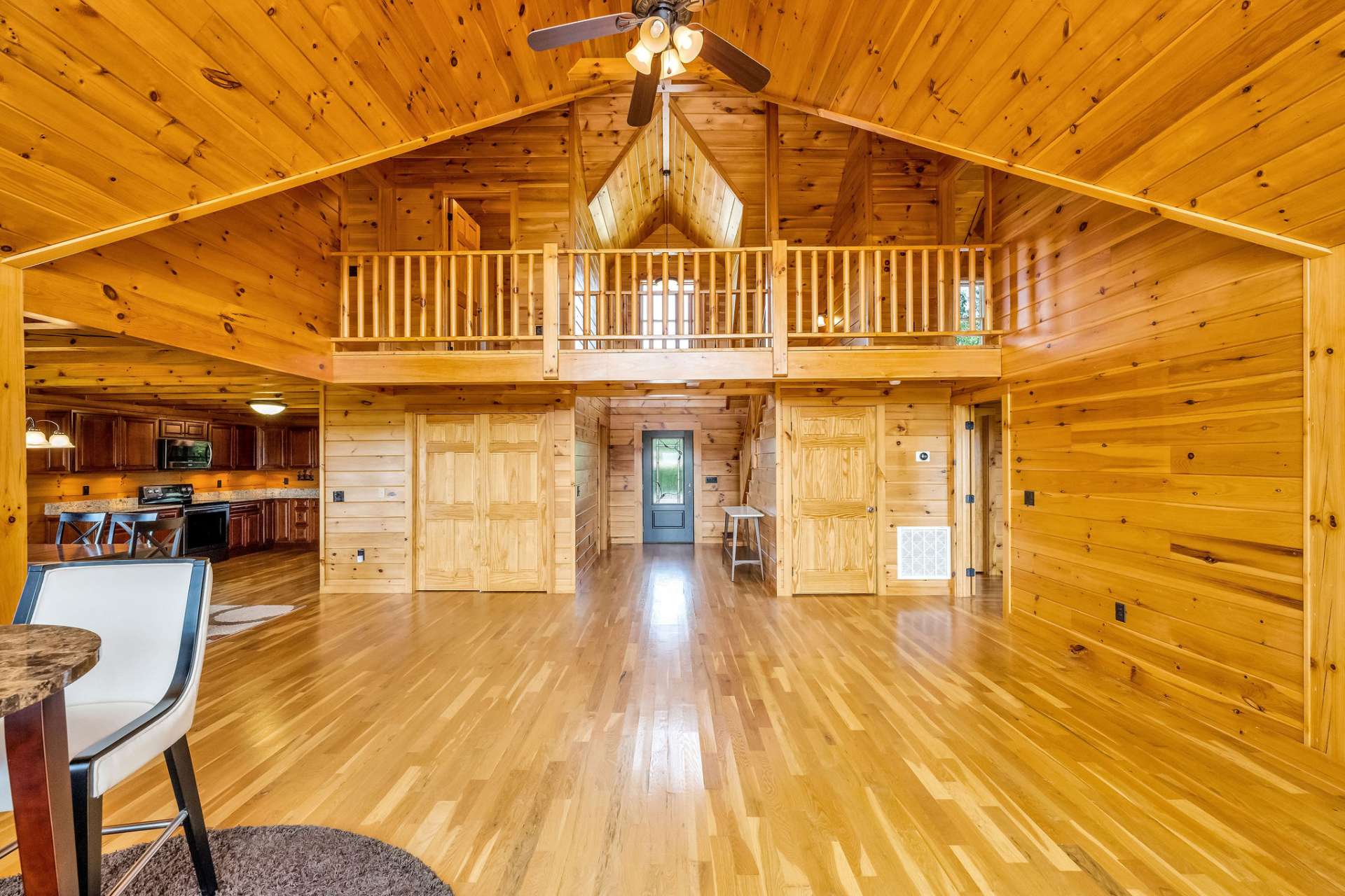 The living area serves as the heart of the home, offering a central gathering space that flows effortlessly into the kitchen and dining areas, while also providing convenient access to the main-level primary bedroom.