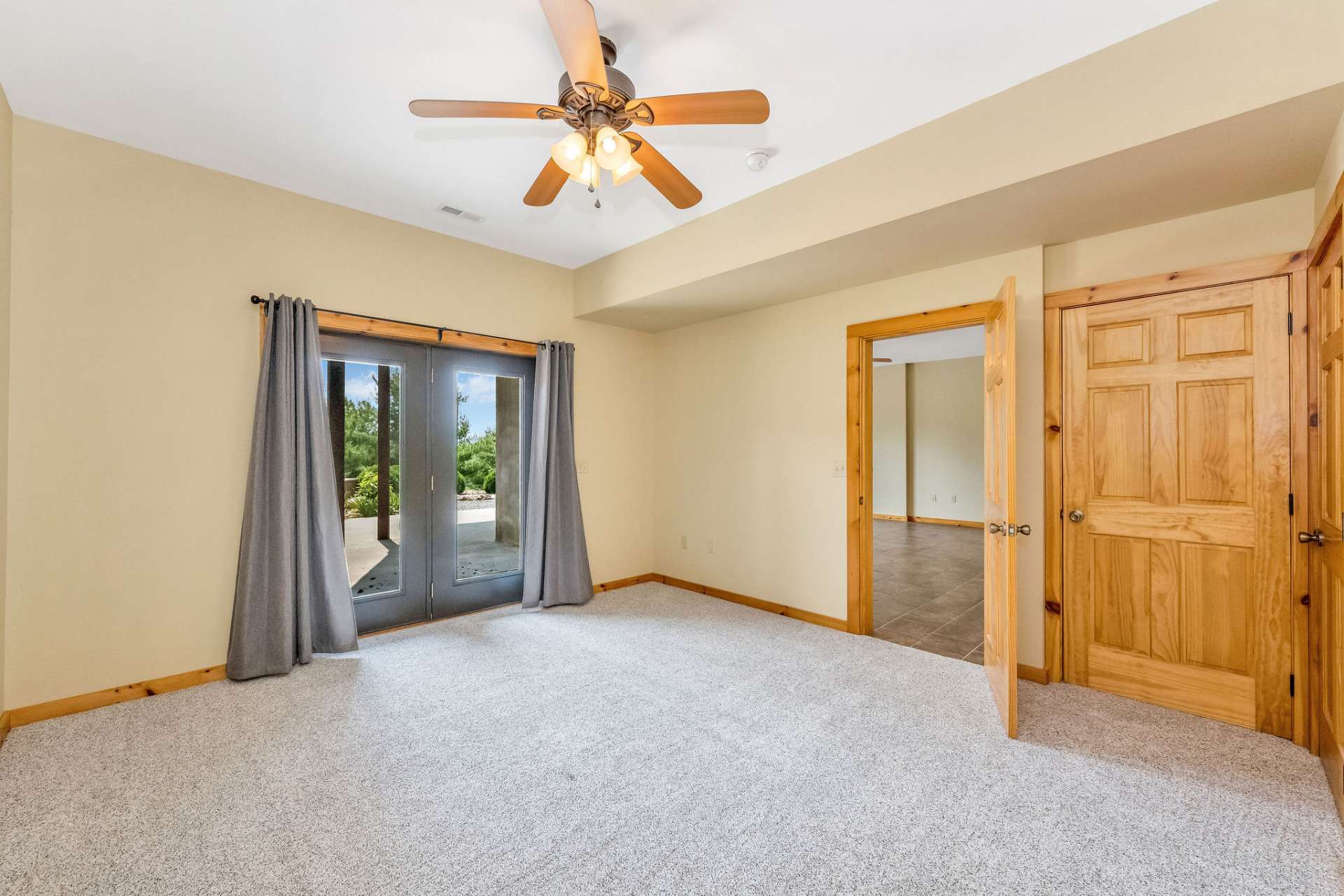 This inviting lower-level bedroom features plush carpeting and a bright, airy layout perfect for rest or relaxation. Step directly from the bedroom onto the patio, blending indoor comfort with easy outdoor enjoyment.