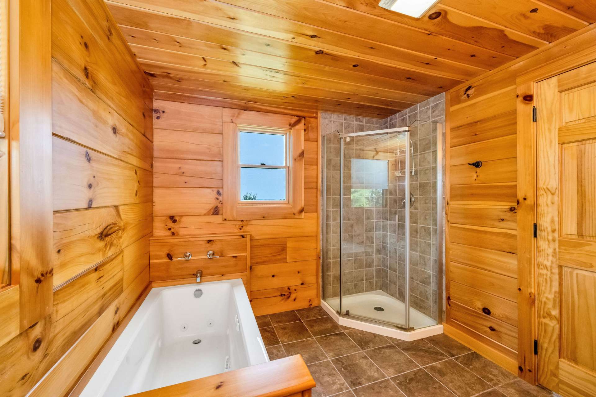 Treat yourself to a soak in the inviting whirlpool tub—perfect for unwinding after a day in the mountains, or a separate corner shower offers added functionality without sacrificing space—ideal for quick refreshes or daily routines.