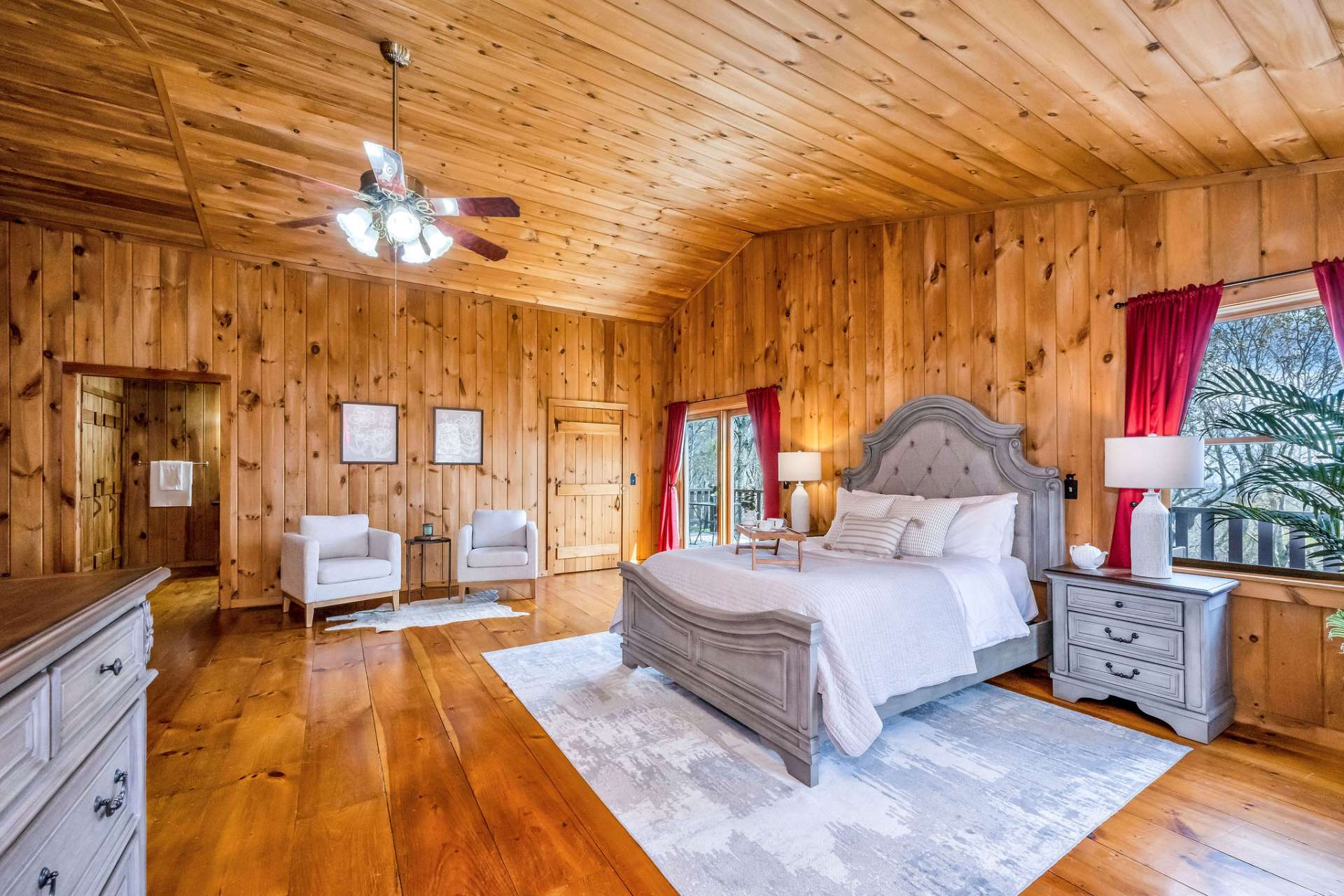 The high ceilings complement the bedroom's spacious dimensions.