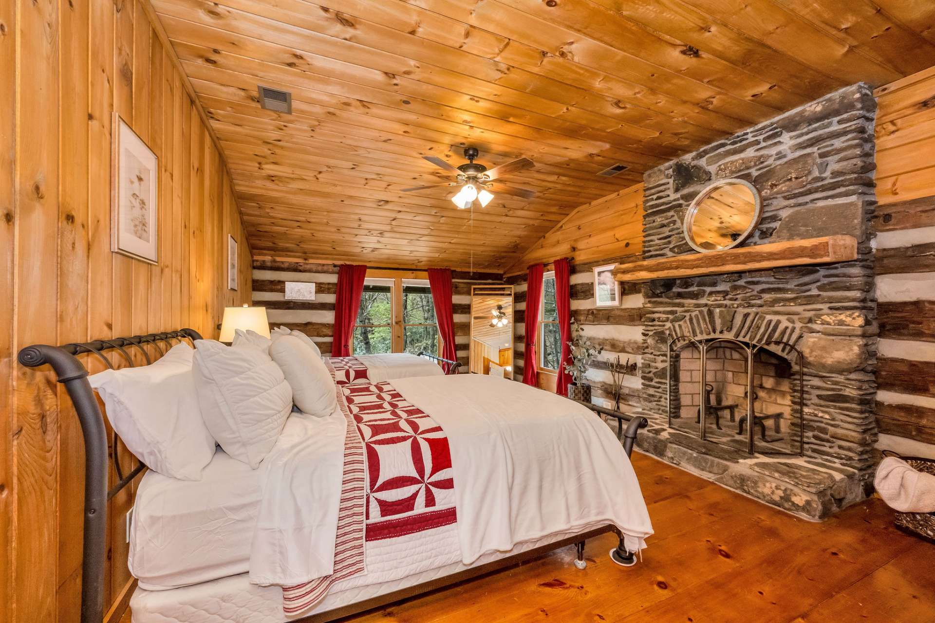 The first guest bedroom features a wood-burning fireplace, creating an elevated cabin experience!