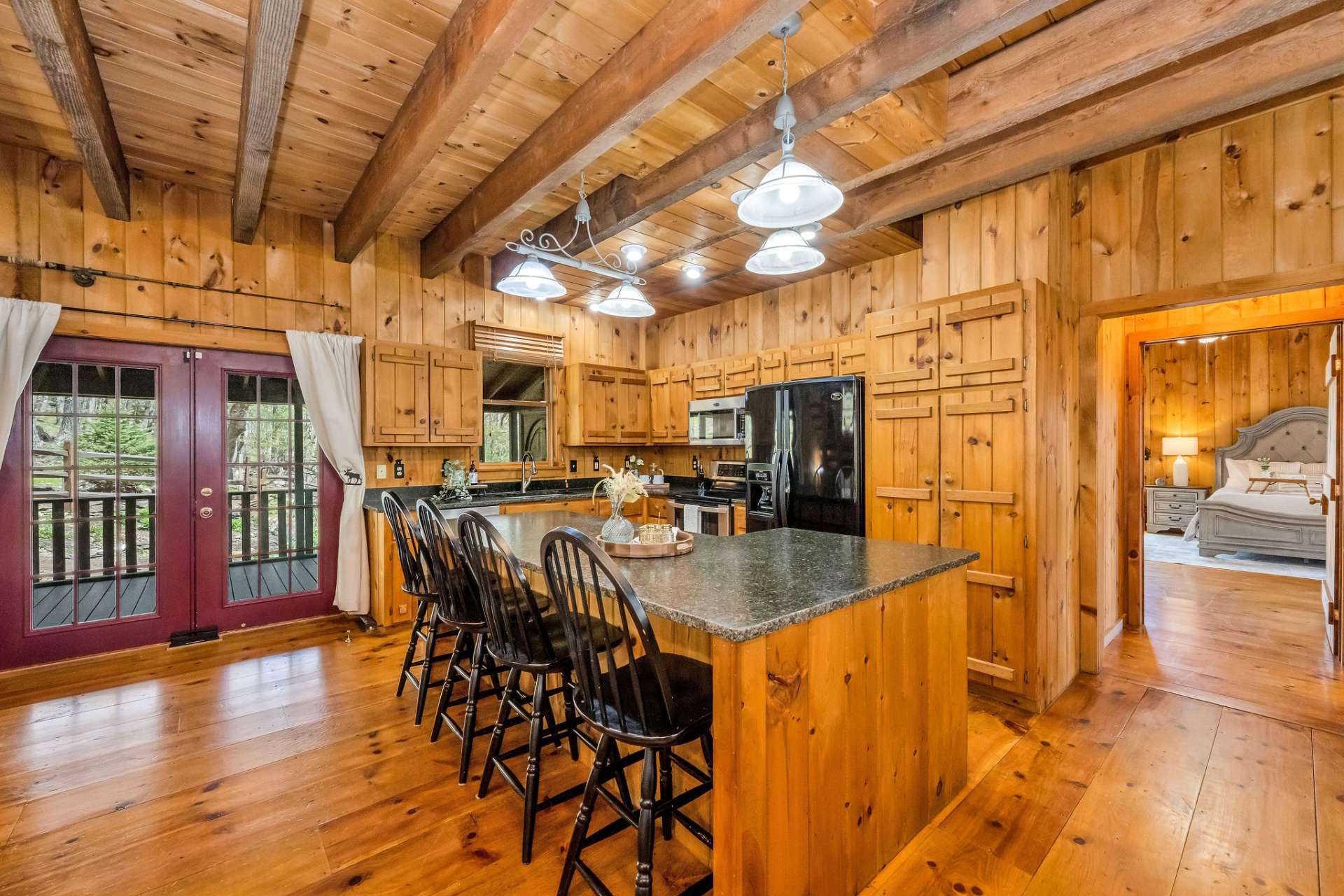 The kitchen features an L-shaped island with casual seating, extra prep and serving space, plus additional storage.