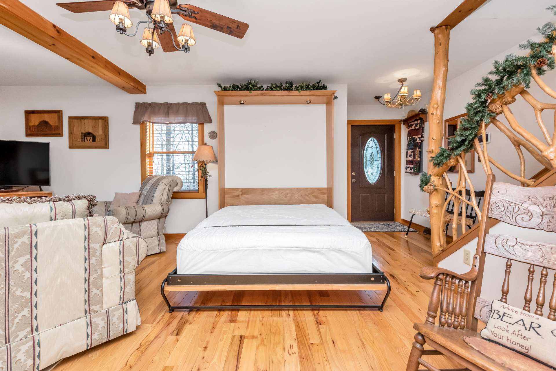 Murphy bed in living room offers additional sleeping for guests.