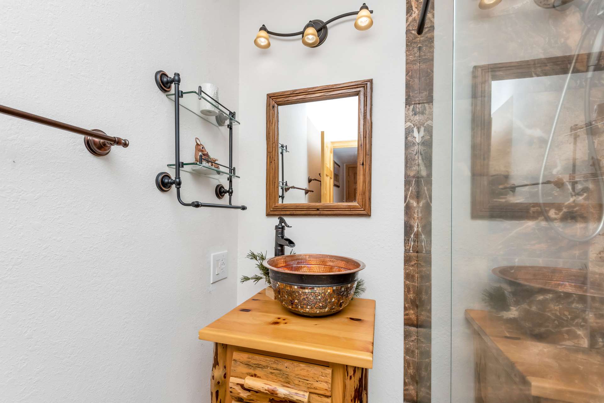 The copper bowl sink tops off the bathroom design.