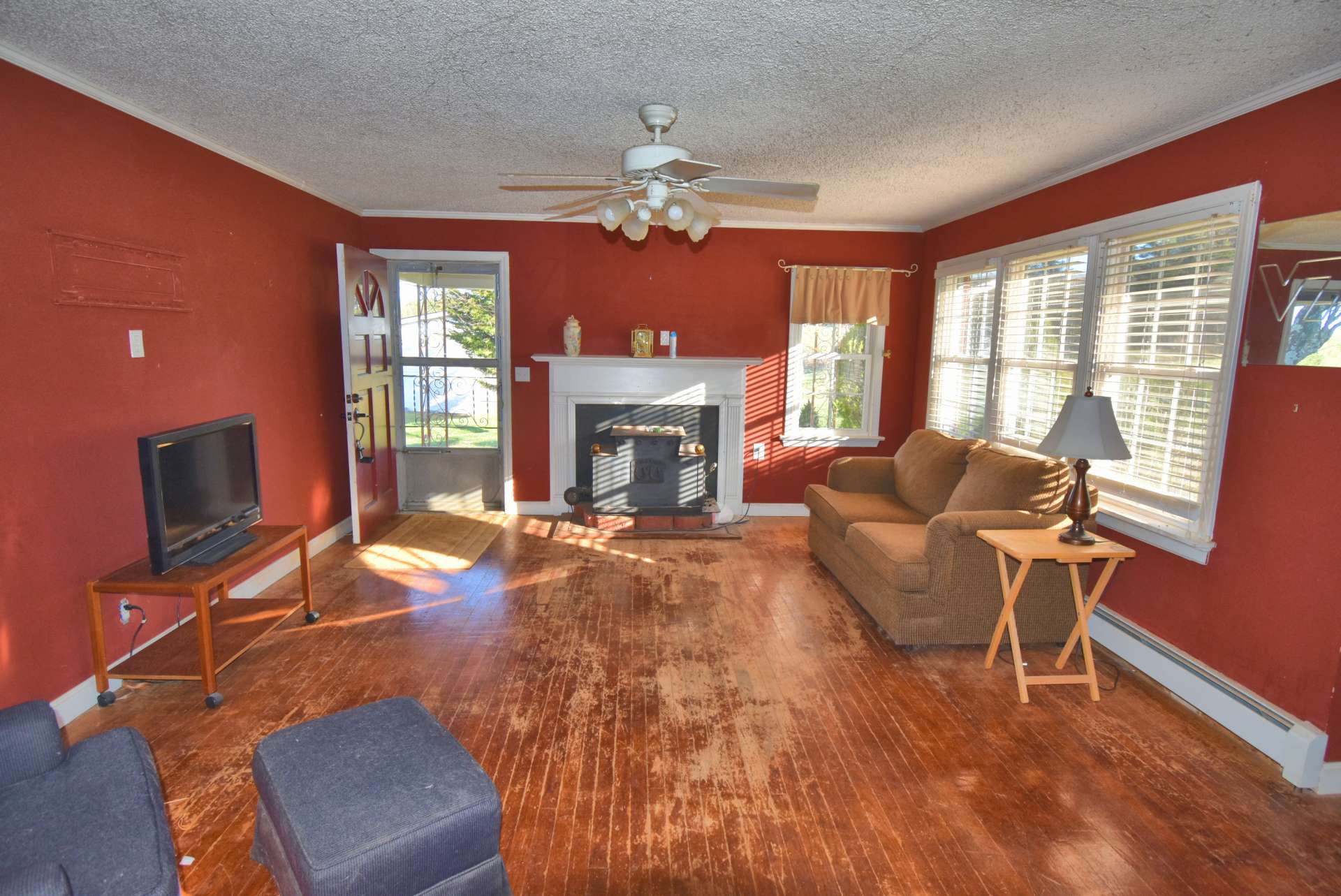 The main home features wood floors and a wood burning fireplace with stove insert in the living room.