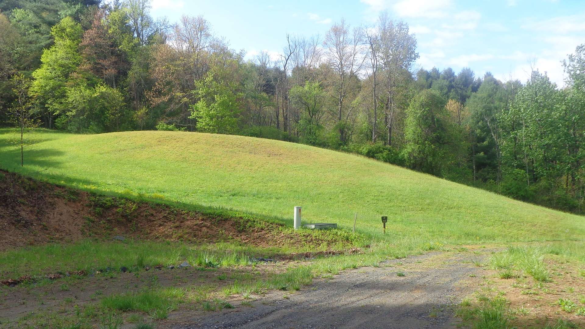 Lot 48 is mostly open with under ground utilities to lot and driveway roughed in.