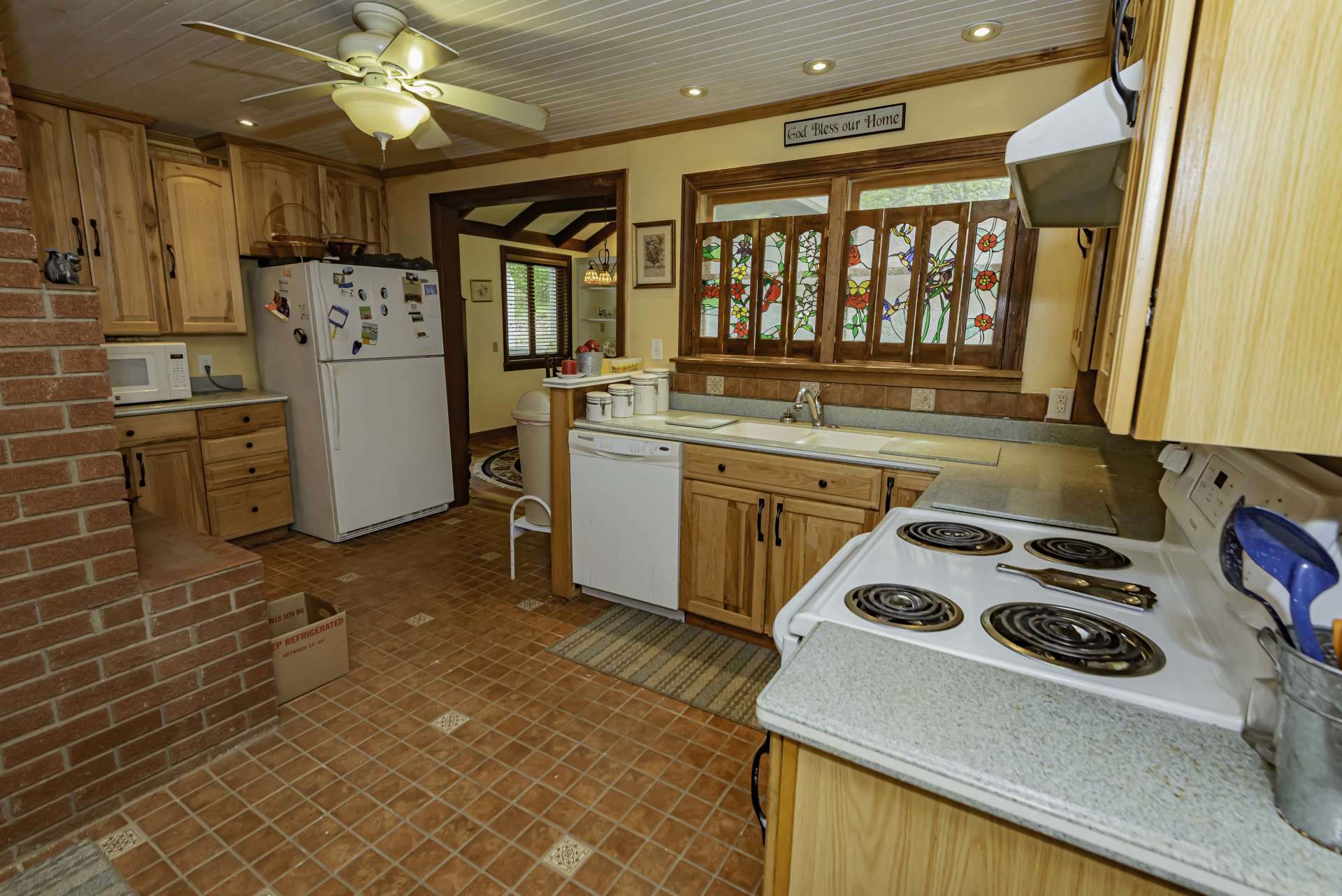 The kitchen offers plenty of work and storage space. Notice the lovely stained glass accents.