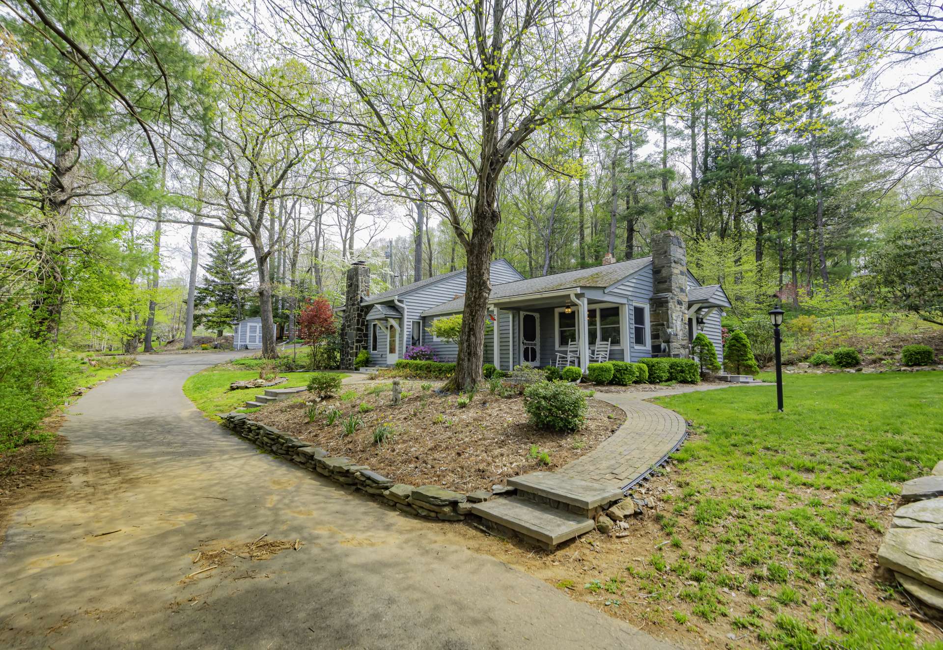 A picturesque setting showcases lovingly sculpted landscaping with a mixture of perennials and native mountain foliage.