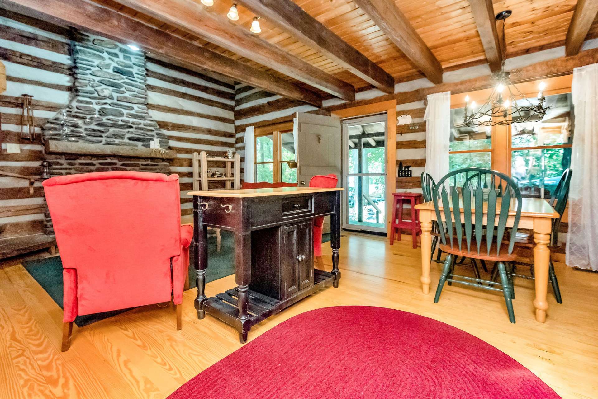 Beautiful wood flooring throughout the cabin. The laundry area is hidden behind double doors just off the primary bedroom.