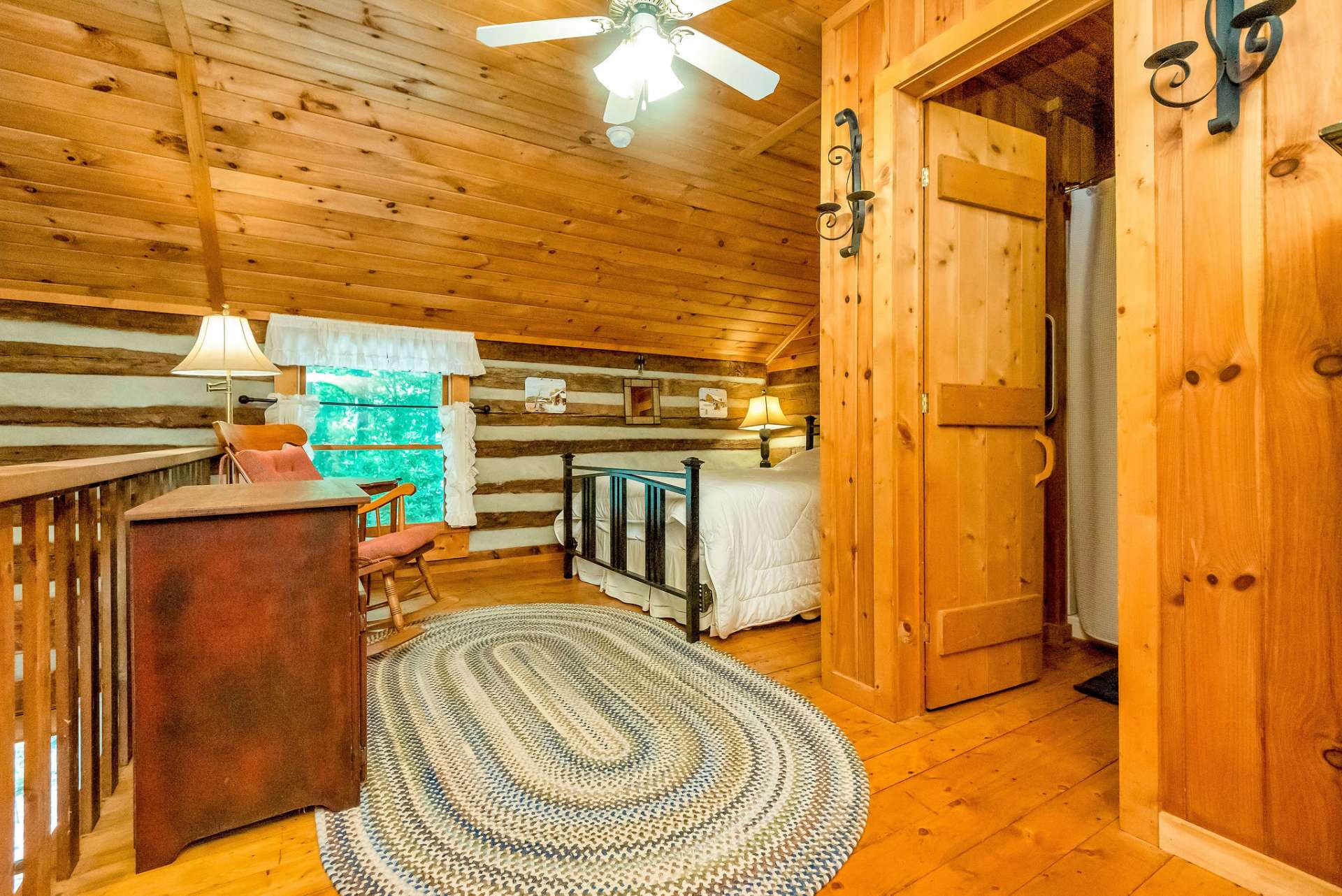 Spacious loft bedroom with full guest bath.